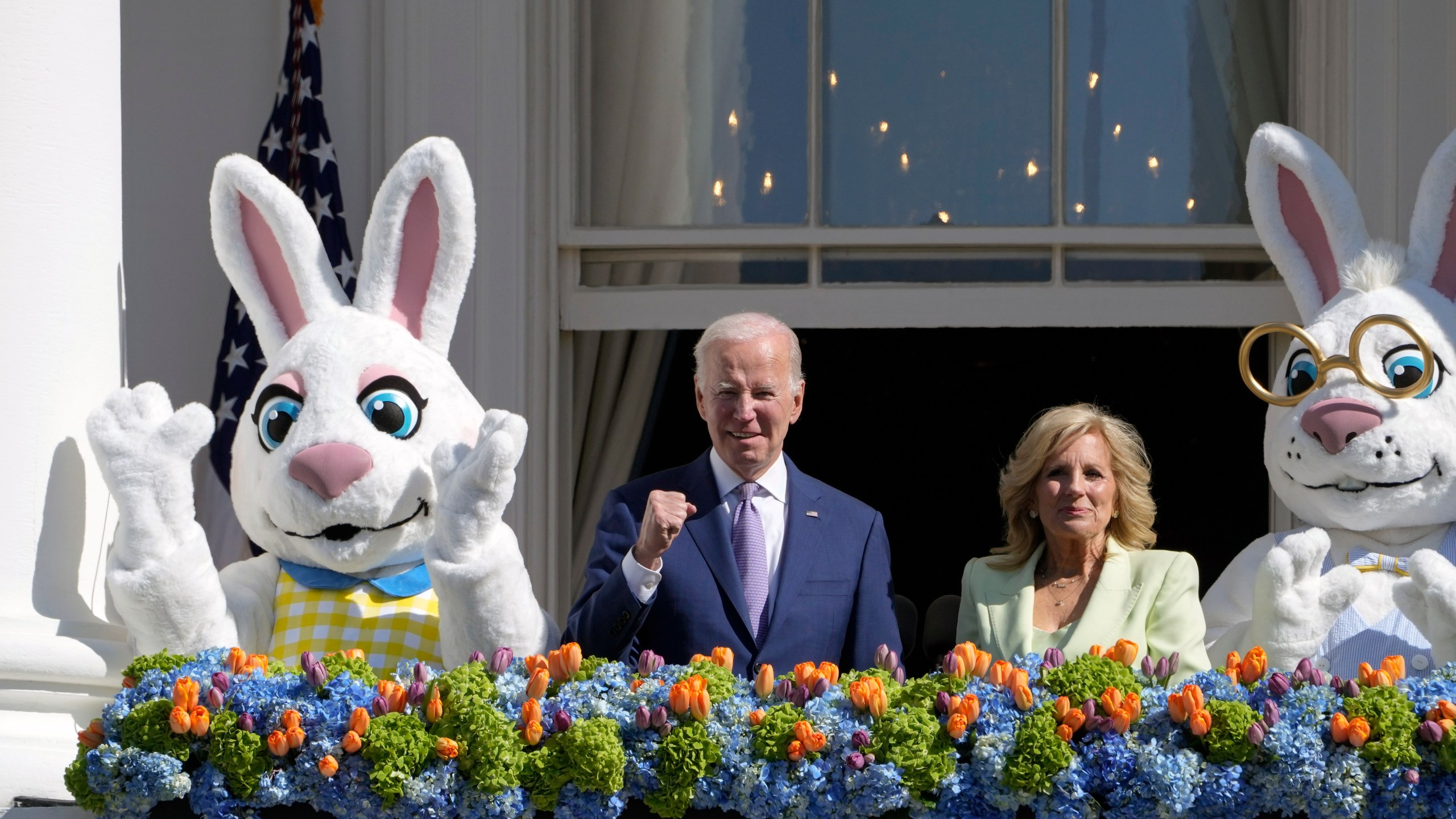 President Joe Biden, accompanied by first lady Jill Biden and Easter Bunnies, stands on the Blue Room Balcony at the White House during the 2023 White House Easter Egg Roll, on Monday, April 10, 2023. (AP Photo/Susan Walsh)