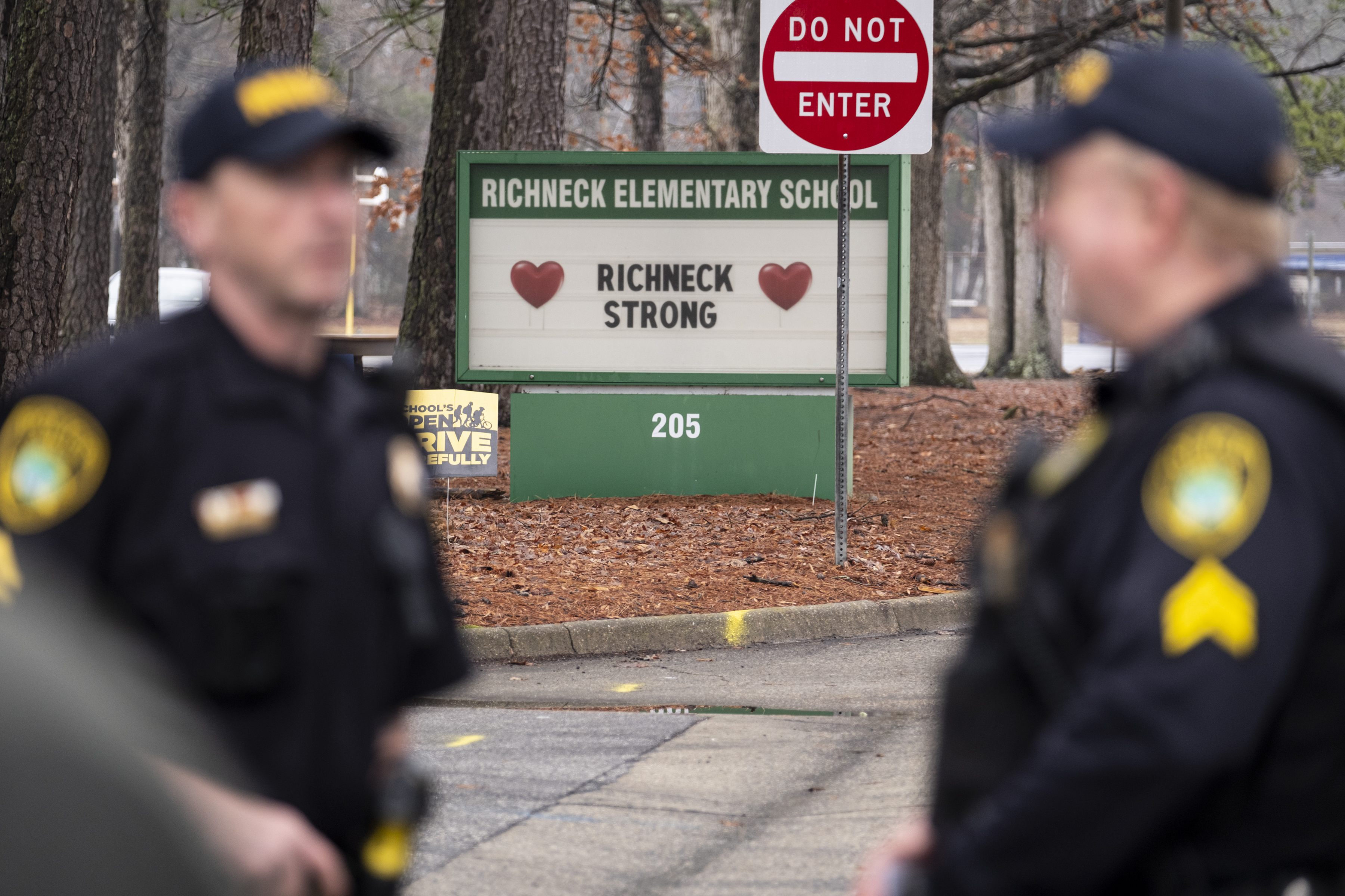 FILE - Police look on as students return to Richneck Elementary on Jan. 30, 2023, in Newport News, Va. The mother of a 6-year-old Virginia boy who shot and wounded his teacher at Richneck Elementary had a series of miscarriages and post-partum depression in the year before the shooting, her attorney said Friday, April 14, 2023, after she was arraigned on charges of child neglect and failing to secure the handgun her son used in the shooting. (Billy Schuerman/The Virginian-Pilot via AP, File)