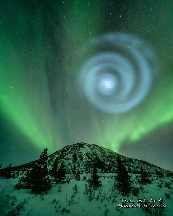 In this photo provided by Todd Salat, northern light enthusiasts got a surprise early April 15, 2023, when something odd was mixed in with the green bands of light dancing above the Donnelly Dome near Delta Junction, Alaska. A light baby blue spiral resembling a galaxy appeared amid the aurora for a few minutes. The spiral was formed when excess fuel that had been released from a SpaceX rocket that launched from California about three hours earlier turned to ice, and then the water vapor reflected the sunlight in the upper atmosphere. (Todd Salat via AP)