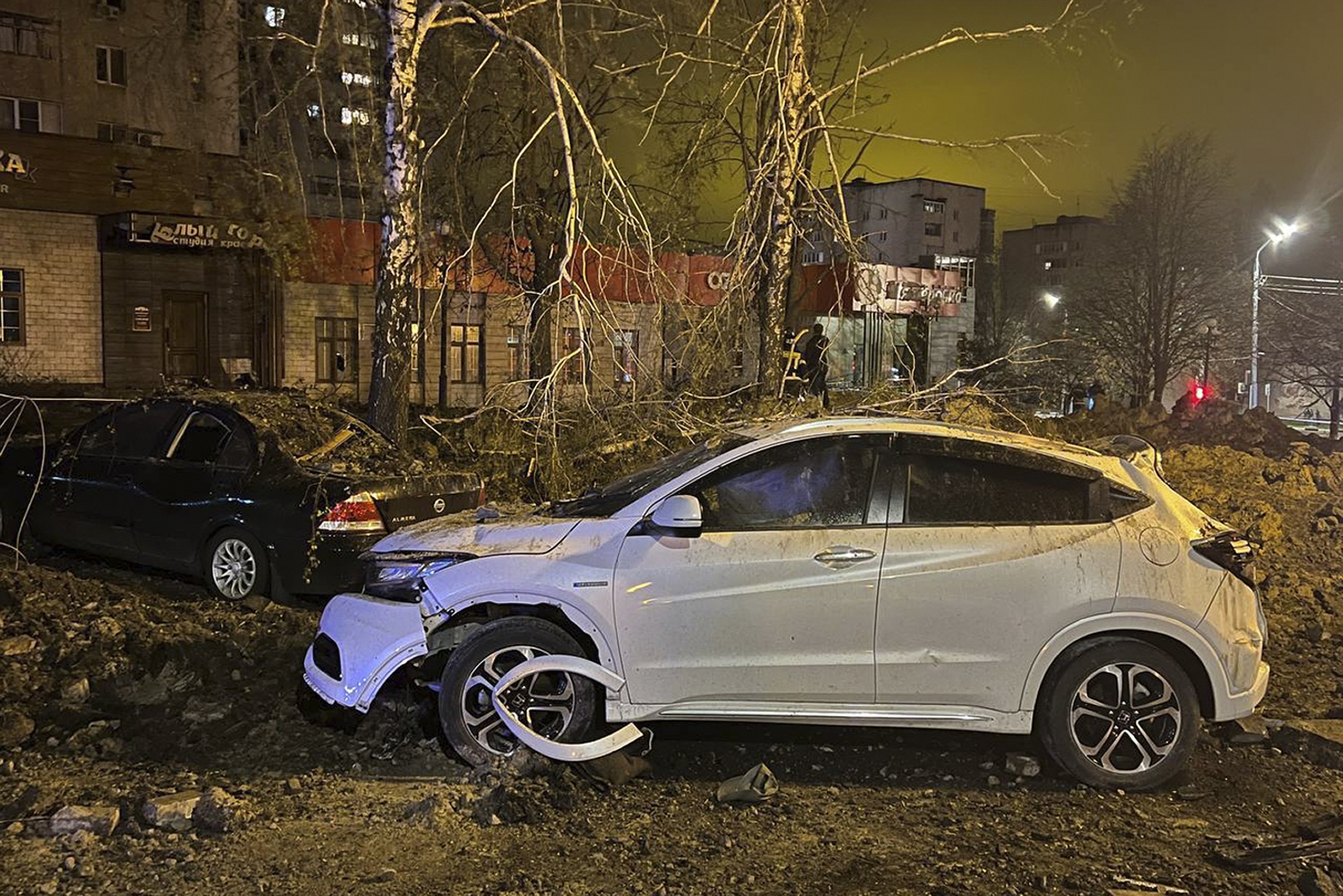 This handout photo released by Telegram Channel of Belgorod Region Governor Vyacheslav Gladkov shows the site of the crater after an explosion in Belgorod, Russia, Friday, April 21, 2023. A large explosion hit Belgorod late Thursday, and the Defense Ministry said one of its Su-34 warplanes accidentally discharged ammunition over the city about 25 km (15 miles) from the Ukrainian border. Belgorod Regional Gov. Vyacheslav Gladkov said the blast injured at least two people, damaged homes and left a crater about 20 meters (65 feet) across. (Telegram Channel of Belgorod Region Governor Vyacheslav Gladkov via AP)