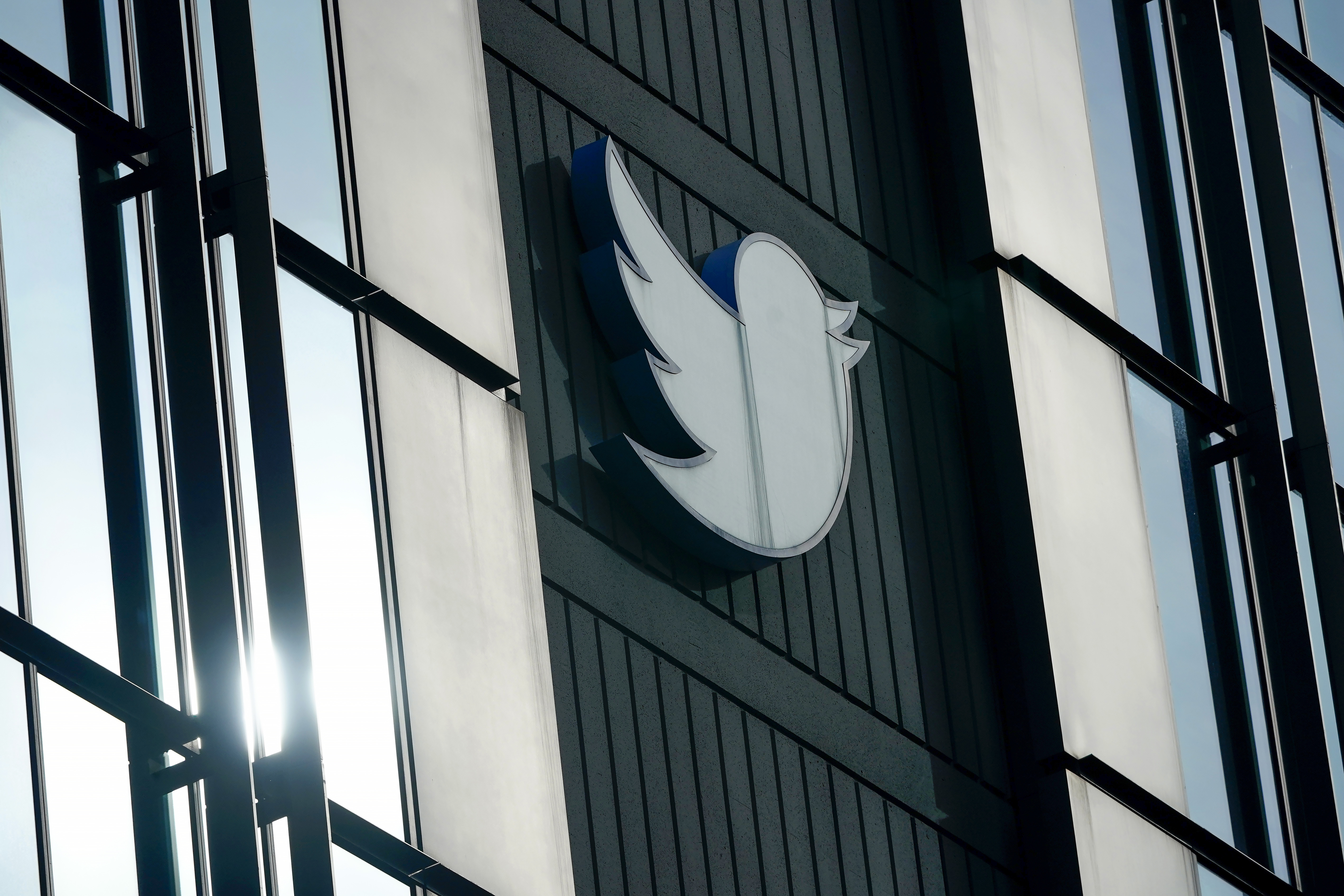 FILE - A Twitter logo hangs outside the company's offices in San Francisco, Dec. 19, 2022. Elon Musk said Thursday, May 11, 2023, that he has found a new CEO for Twitter, or X Corp. as it is now called. He did not name the person but she will be starting in about six weeks. (AP Photo/Jeff Chiu, File)