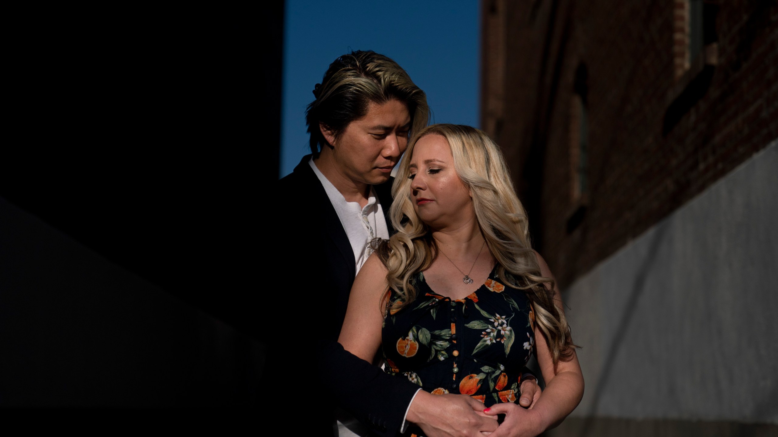 Jessica Tincopa and her husband, Rob Tran, stand for a portrait in Orange, Calif., Friday, May 5, 2023. Tincopa may leave the photography business she spent 14 years building for one reason: to find coverage for fertility treatment. After six miscarriages, Tincopa and her husband started saving for in vitro fertilization, which can cost well over $20,000, but the pandemic wiped out their savings and the state's health insurance marketplace doesn't cover things like IVF. (AP Photo/Jae C. Hong)