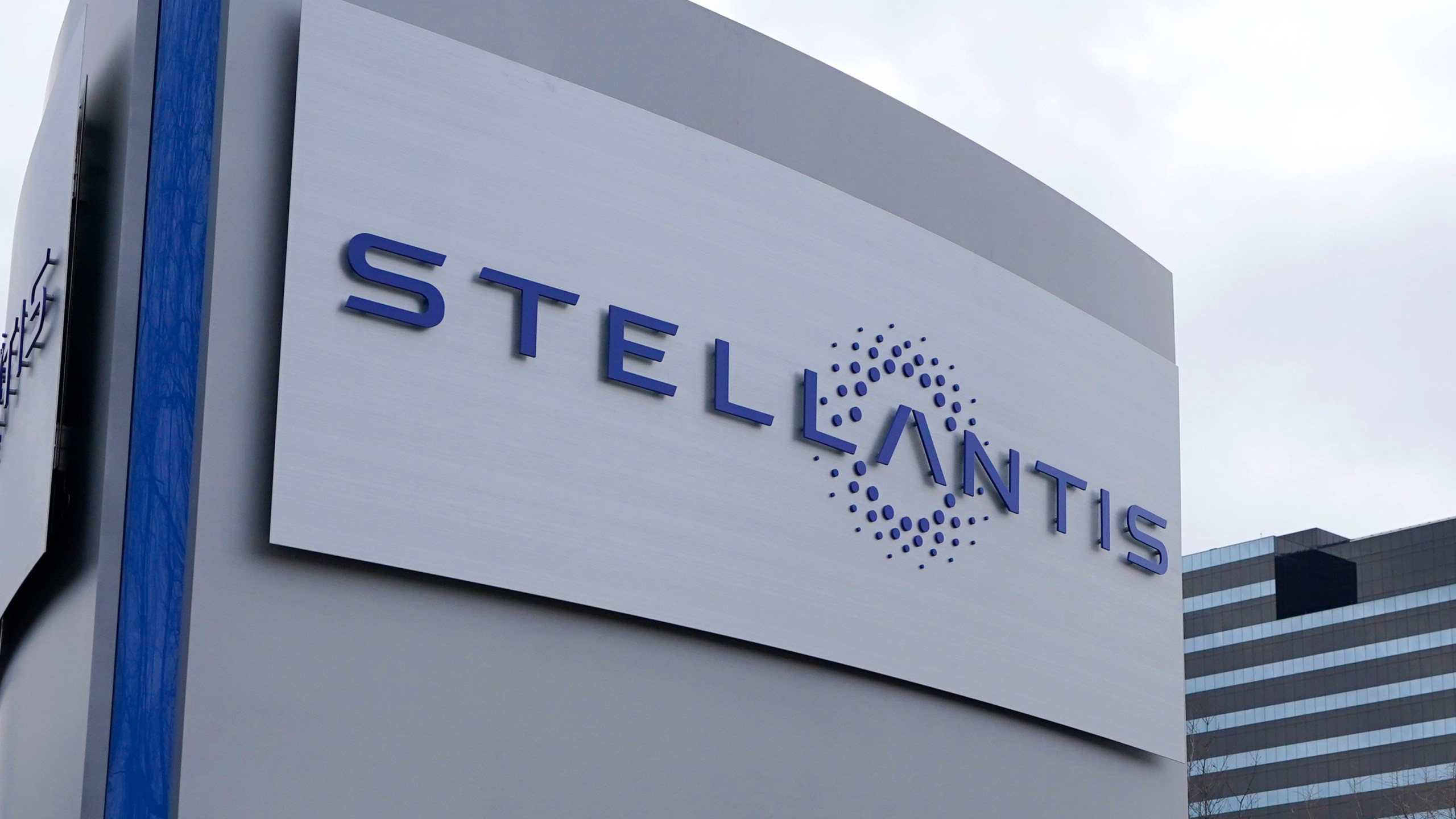 FILE - A Stellantis sign is seen outside the Chrysler Technology Center, Jan. 19, 2021, in Auburn Hills, Mich. Stellantis has warned of a potential existential threat to large parts of the British car industry unless the government moves to alter the terms of its Brexit trade deal with the European Union. In a submission to a parliamentary inquiry into the supply of batteries for electric vehicles released Wednesday, May 17, 2023, the parent company of Citroen, Fiat, Peugeot and Vauxhall said it may not be able to keep its commitment to manufacture its new fleet of cars in the U.K. without changes to the terms of the deal. (AP Photo/Carlos Osorio, File)