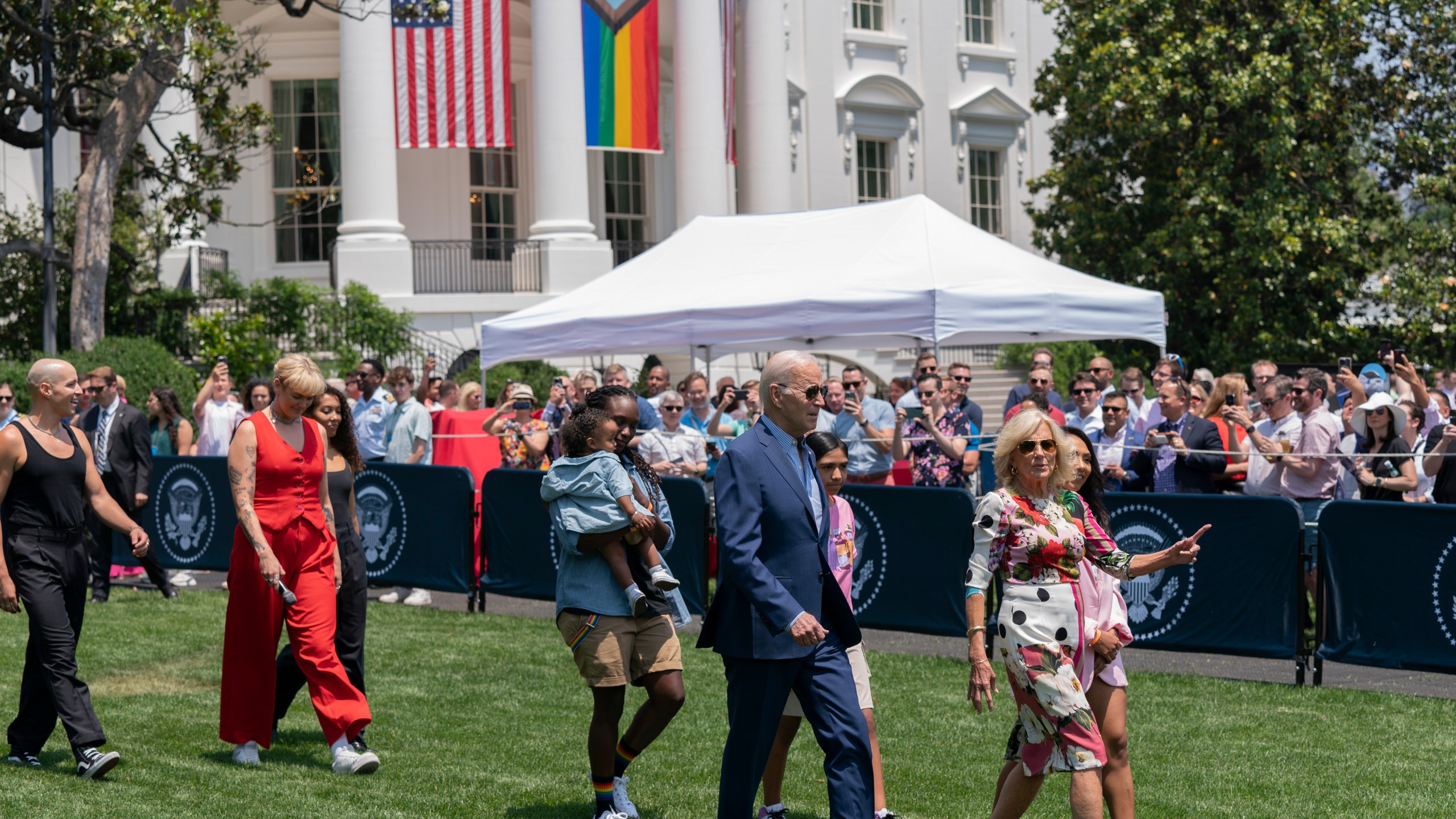 President Joe Biden, first lady Jill Biden and Betty Who, left in red, arrive for a Pride Month celebration on the South Lawn of the White House, Saturday, June 10, 2023, in Washington. (AP Photo/Manuel Balce Ceneta)