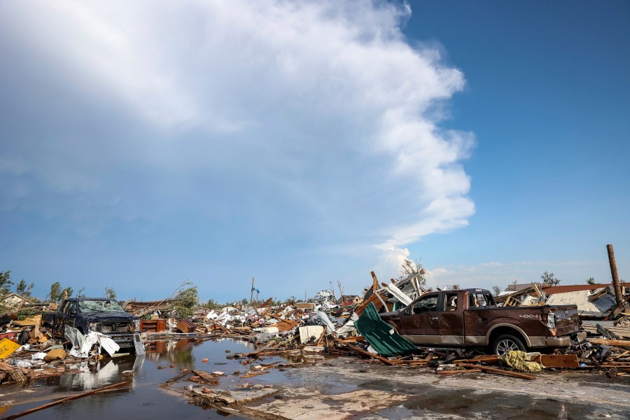 Damaged pickup trucks sit among debris after a tornado passed through a residential area in Perryton, Texas, Thursday, June 15, 2023. (AP Photo/David Erickson)