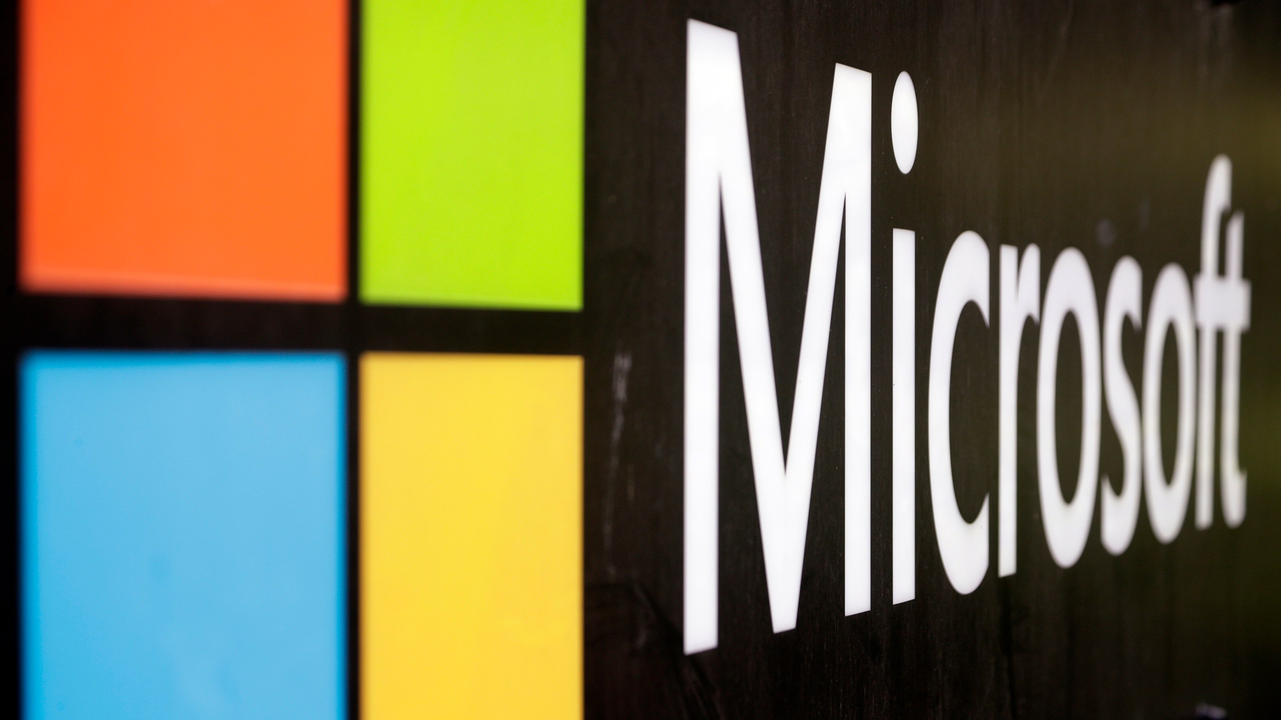 FILE - The Microsoft company logo is displayed at their offices in Sydney, Australia, on Feb. 3, 2021. Microsoft says the early June 2023 disruptions to its Microsoft’s flagship office suite — including the Outlook email and OneDrive file-sharing apps — were denial-of-service attacks by a shadowy new hacktivist group. (AP Photo/Rick Rycroft, File)