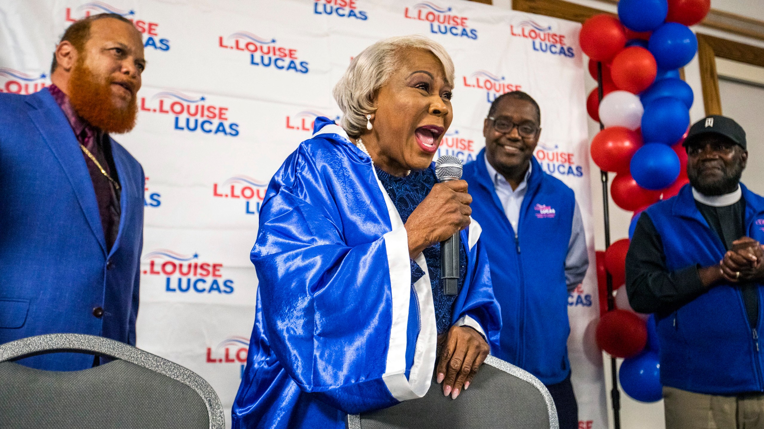 Donning a boxing robe, Sen. Louise Lucas celebrates her win for Virginia's 18th District State Senate Democratic nomination at Bide-A-Wee golf course in Portsmouth, Va., on Tuesday, June 20, 2023. (Kendall Warner/The Virginian-Pilot via AP)