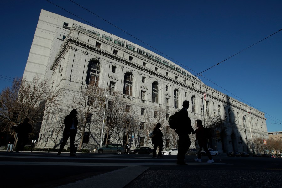 FILE - People walk past The Earl Warren Building, headquarters of the Supreme Court of California, on Jan. 7, 2020 in San Francisco. On Thursday, June 22, 2023, the Supreme Court of California ruled that police are not immune from civil lawsuits for misconduct that happens during investigations. (AP Photo/Jeff Chiu, File)