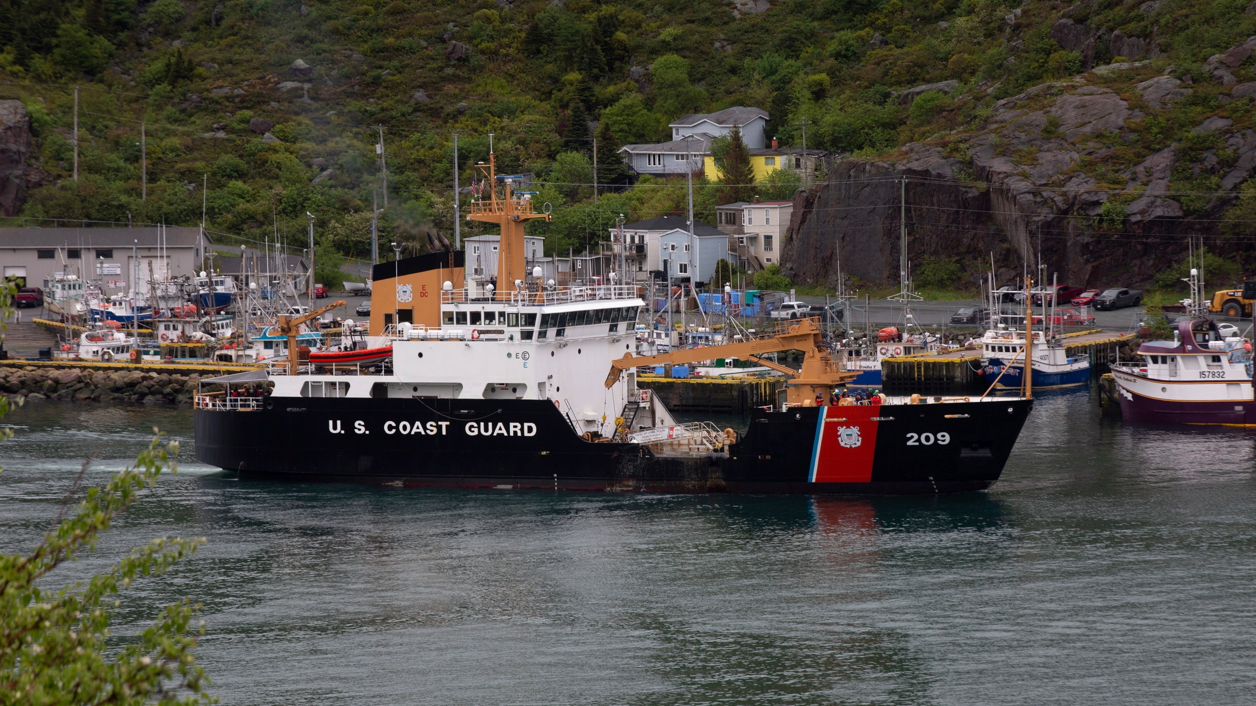 A U.S. Coast Guard ship arrives in the harbor of St. John's, Newfoundland, on Wednesday, June 28, 2023, following the arrival of the ship Horizon Arctic carrying debris from the Titan submersible. The submersible owned by OceanGate Expeditions imploded on its way to the wreck of the Titanic. (Paul Daly/The Canadian Press via AP)