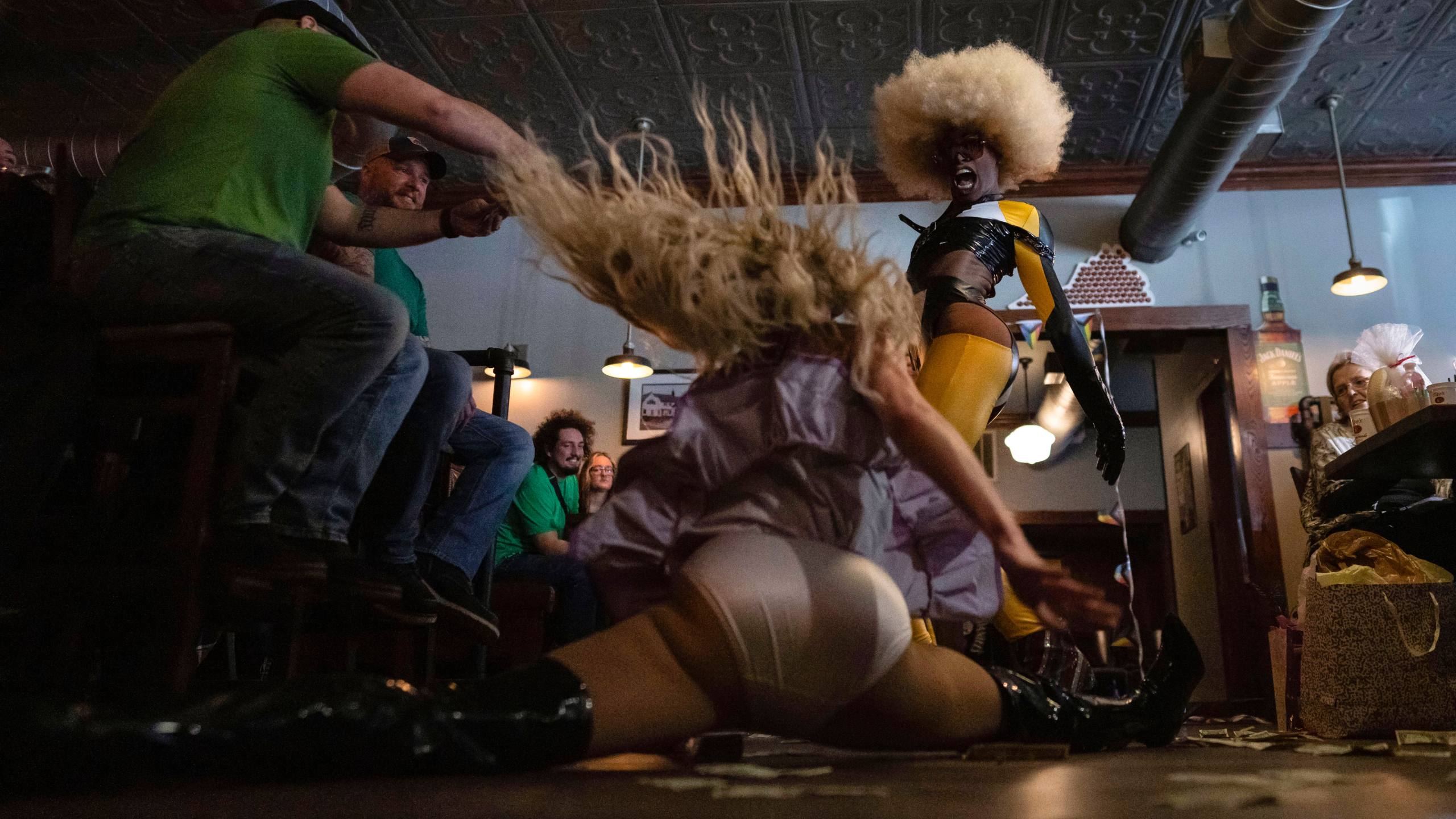 Javon Love, right, performs with Baby Angel, doing the splits, during "Mimosas & Heels Drag Brunch" at the Public House, Sunday, March 5, 2023, in Norfolk, Va. The drag bunch was hosted by Harpy Daniels and Javon Love. (AP Photo/Carolyn Kaster)