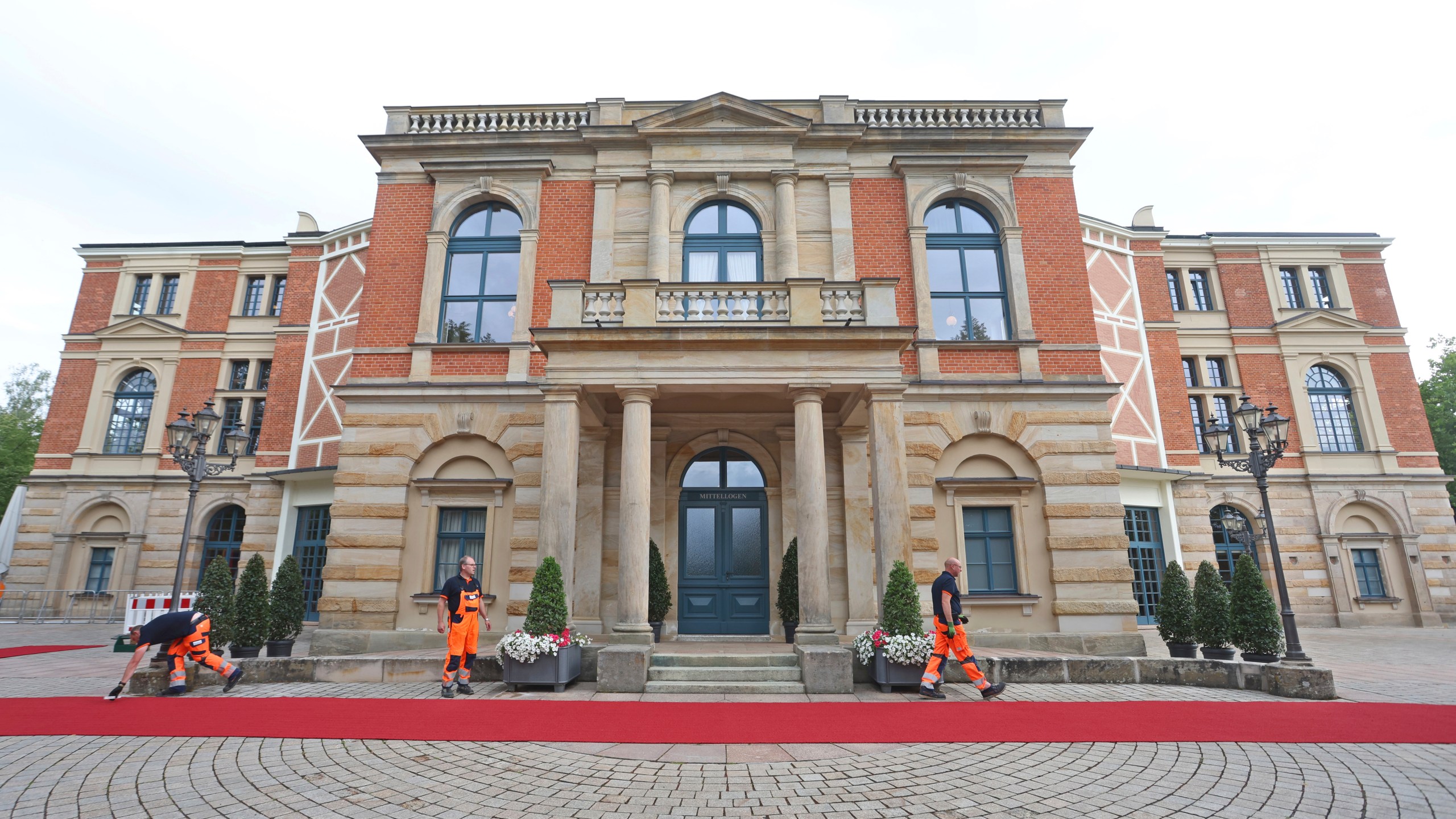 The red carpet is fixed in front of the Festspielhaus for the opening of the Bayreuth Richard Wagner Festival in Bayreuth, Germany, Tuesday July 25, 2023. (Karl-Josef Hildenbrand/dpa via AP)