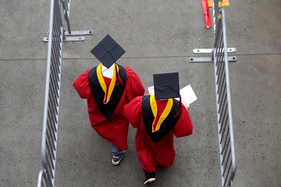 FILE - Graduates walk into High Point Solutions Stadium before the start of the Rutgers University graduation ceremony in Piscataway Township, N.J., on May 13, 2018. With the help of a nonprofit that focuses on civic education, the presidents of a wide-ranging group of 13 universities have decided to elevate free speech on their campuses this academic year. (AP Photo/Seth Wenig, File)