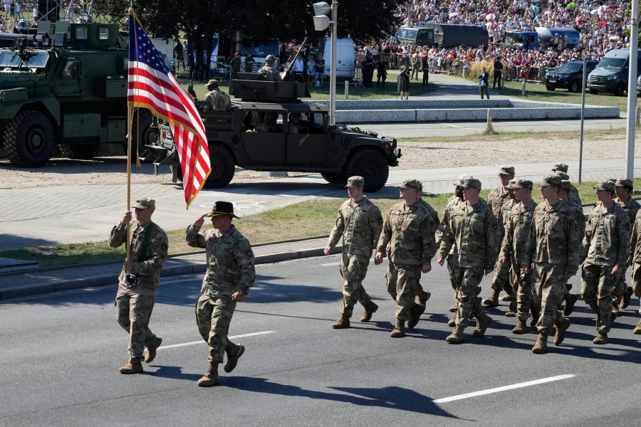 Representative of allied U.S. troops march in a massive military parade to celebrate the Polish Army Day, commemorating the 1920 battle in which Polish troops defeated advancing Bolshevik forces, in Warsaw, Poland, Tuesday, Aug. 15, 2023. Poland is holding a military parade to showcase its state-of-the-art weapons and defense systems, as war rages across its southeastern border in neighboring Ukraine and ahead of parliamentary elections scheduled for Oct. 15. (AP Photo/Czarek Sokolowski)