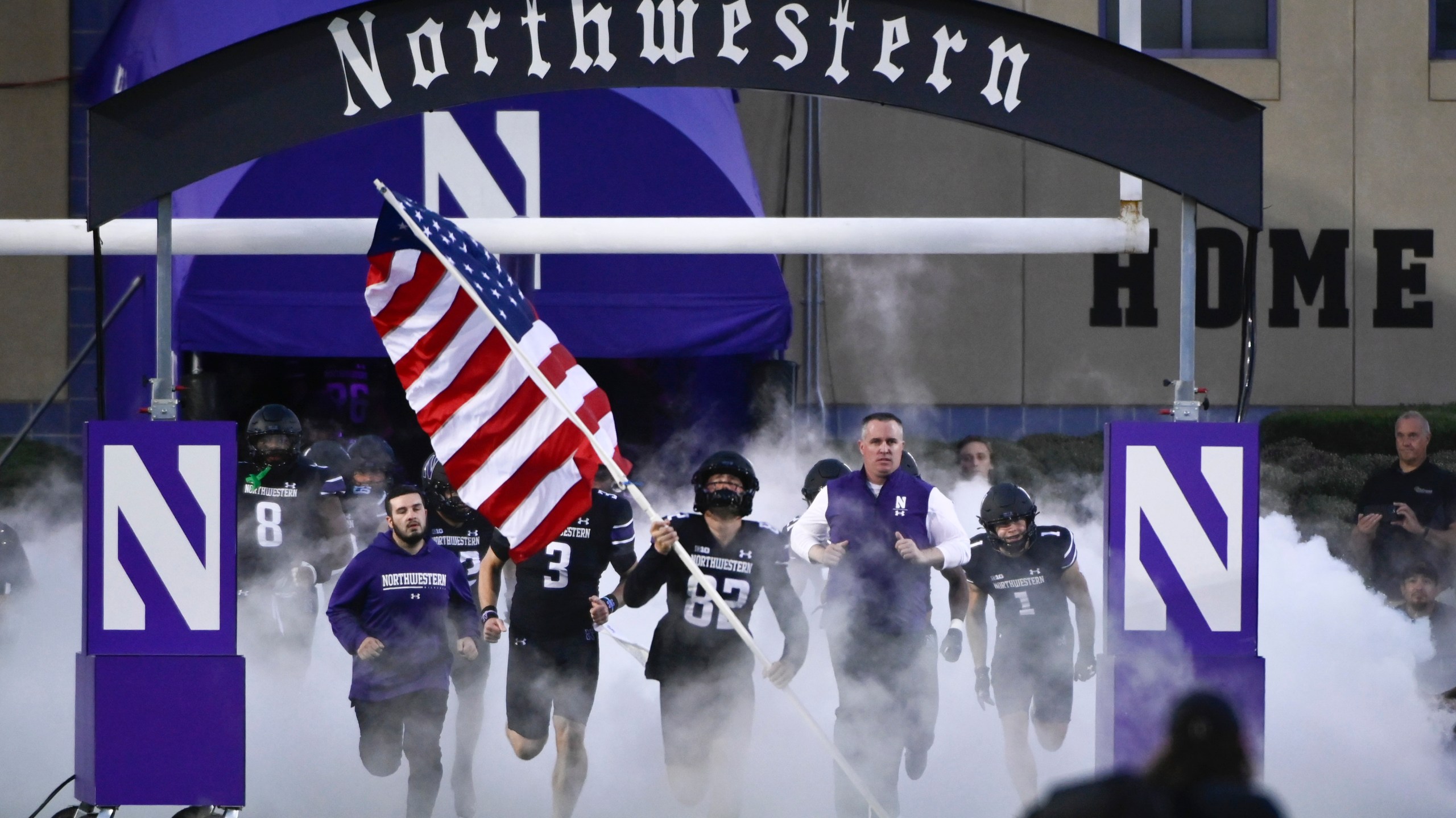 FILE - Northwestern coach Pat Fitzgerald, right, leads the team onto the field for the team's NCAA college football game against Miami (Ohio) on Sept. 24, 2022, in Evanston, Ill. Approximately 1,000 former Northwestern University athletes sent a letter, obtained by The Associated Press on Thursday, Aug. 17, 2023, condemning hazing while defending the school's culture, saying allegations of abuse within the football program and other men's and women's teams do not reflect their experiences. Coach Fitzgerald was fired in July 2023 after 17 seasons amid the hazing scandal. (AP Photo/Matt Marton, File)