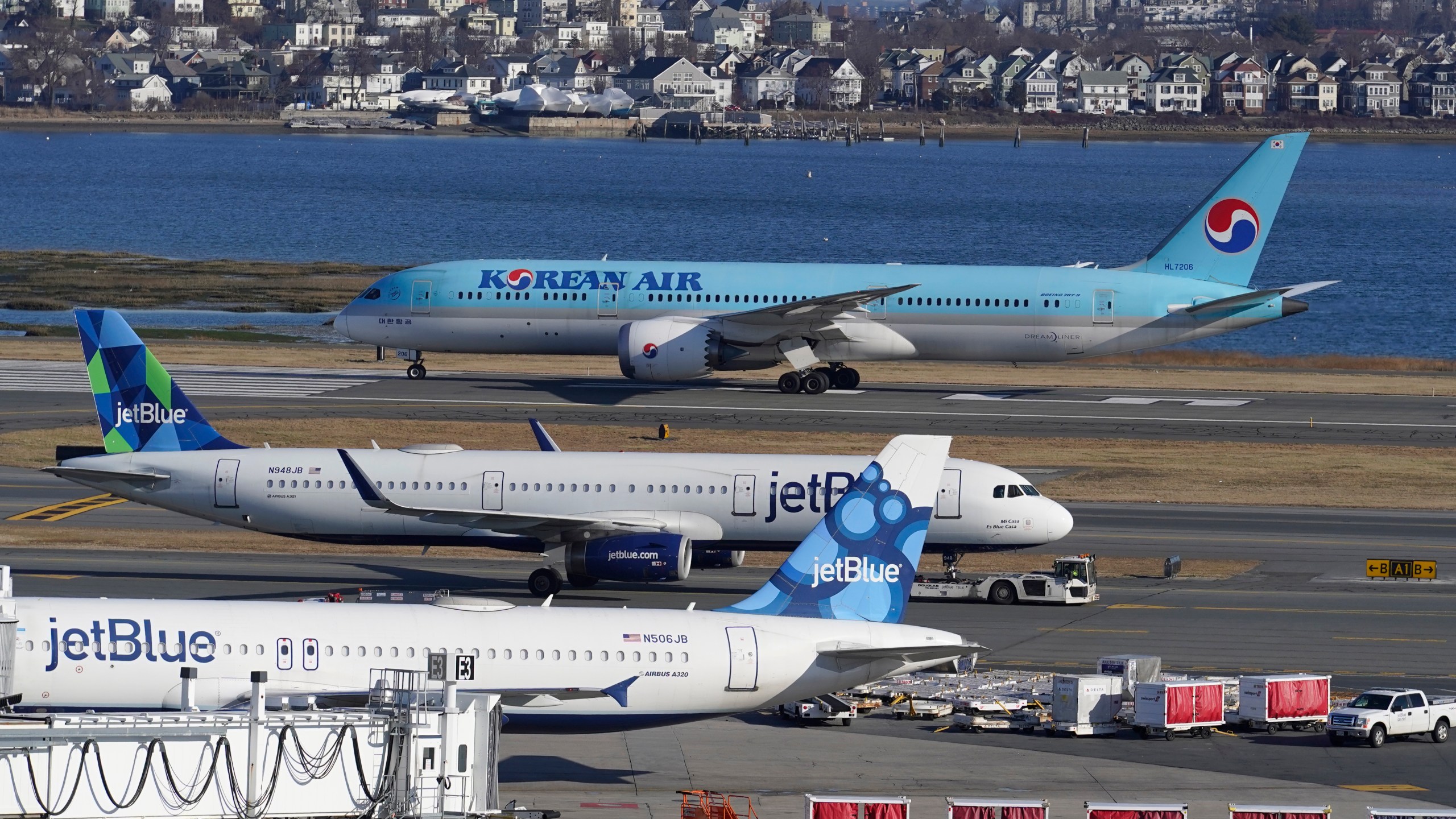 FILE - Passenger jets are seen on the tarmac at Logan International Airport, Jan. 11, 2023, in Boston. The Federal Aviation Administration is considering requiring that all planes be equipped with technology designed to prevent close calls around airports, Friday, Sept. 8. (AP Photo/Steven Senne, File)