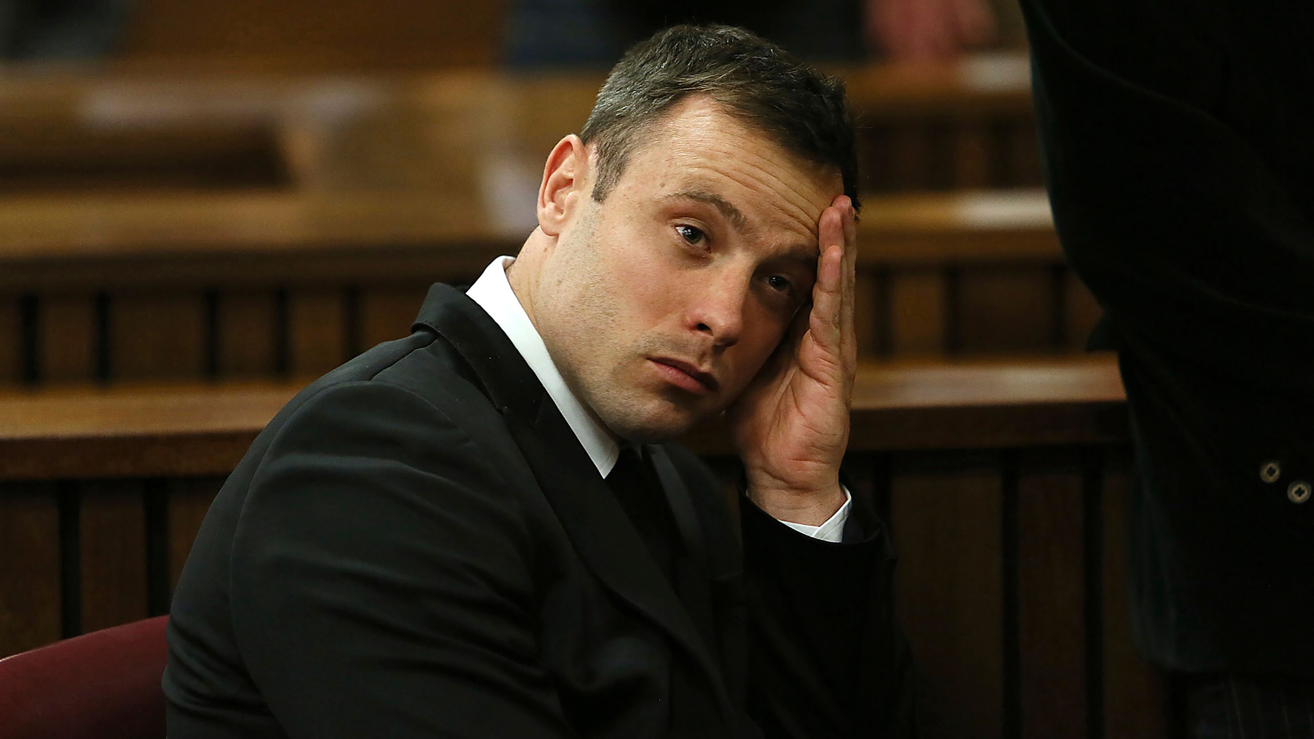 FILE - Oscar Pistorius gestures, at the end of the fourth day of sentencing proceedings in the high court in Pretoria, South Africa, Thursday, Oct. 16, 2014. Pistorius was eligible for parole in March under South African law and the double-amputee Olympic runner may have been wrongly denied early release from prison then due to an error over when he began serving his murder sentence, new court documents show. Justice and correctional services authorities submitted the papers to the country's apex Constitutional Court on Tuesday, Sept. 19, 2023, saying they will not oppose an appeal by Pistorius that he has served the prescribed amount of time in jail and should be declared eligible for parole immediately. (Alon Skuy/Pool Photo via AP, File)