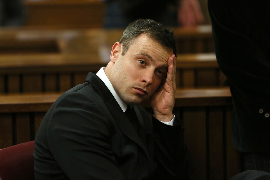 FILE - Oscar Pistorius gestures, at the end of the fourth day of sentencing proceedings in the high court in Pretoria, South Africa, Thursday, Oct. 16, 2014. Pistorius was eligible for parole in March under South African law and the double-amputee Olympic runner may have been wrongly denied early release from prison then due to an error over when he began serving his murder sentence, new court documents show. Justice and correctional services authorities submitted the papers to the country's apex Constitutional Court on Tuesday, Sept. 19, 2023, saying they will not oppose an appeal by Pistorius that he has served the prescribed amount of time in jail and should be declared eligible for parole immediately. (Alon Skuy/Pool Photo via AP, File)