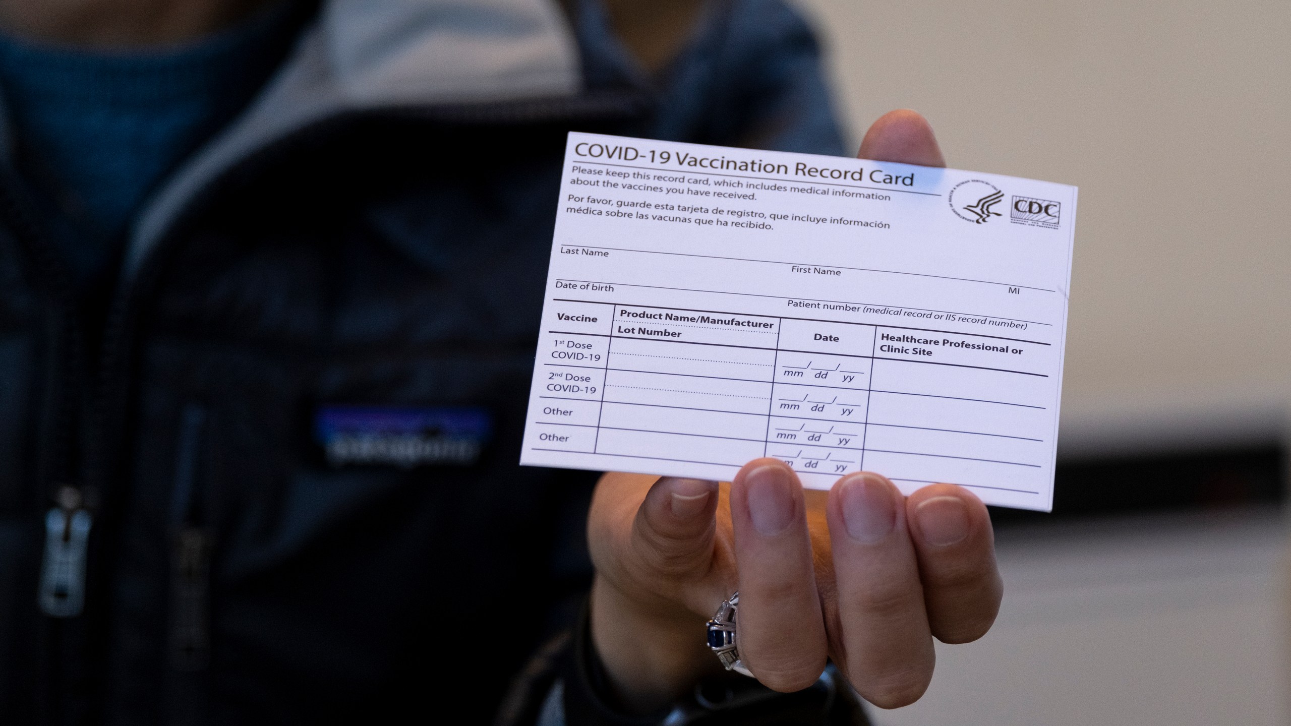 FILE - A nurse practitioner holds a COVID-19 vaccine card at a New York Health and Hospitals vaccine clinic in the Brooklyn borough of New York on Jan. 10, 2021. Now that COVID-19 vaccines are being distributed through the commercial markets instead of by the federal government in 2023, the Centers for Disease Control and Prevention won't be shipping out any more new cards. (AP Photo/Craig Ruttle, File)