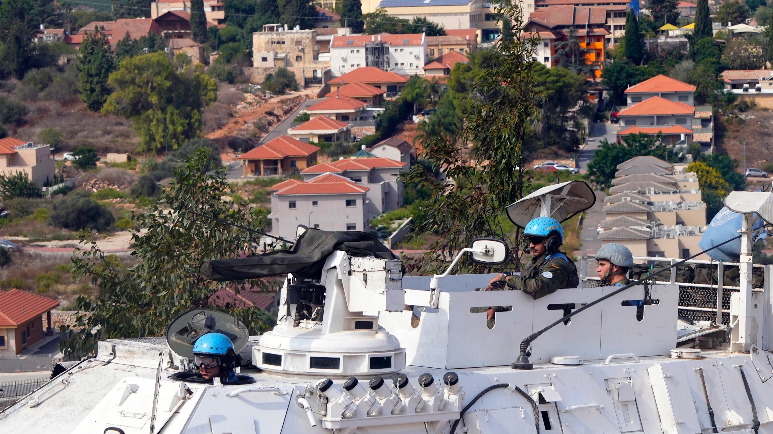 U.N. peacekeepers patrol on the Lebanese side of the Lebanese-Israeli border in the southern village of Kfar Kila, with the Israeli town of Metula in the background, Lebanon, Monday, Oct. 9, 2023. Lebanese and Israeli army soldiers have gathered in larger numbers along the border Monday, the U.N.-drawn Blue Line, after Israeli troops and militant group Hezbollah exchanged shelling on Sunday. (AP Photo/Hassan Ammar)