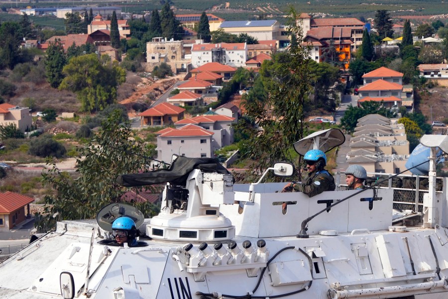 U.N. peacekeepers patrol on the Lebanese side of the Lebanese-Israeli border in the southern village of Kfar Kila, with the Israeli town of Metula in the background, Lebanon, Monday, Oct. 9, 2023. Lebanese and Israeli army soldiers have gathered in larger numbers along the border Monday, the U.N.-drawn Blue Line, after Israeli troops and militant group Hezbollah exchanged shelling on Sunday. (AP Photo/Hassan Ammar)