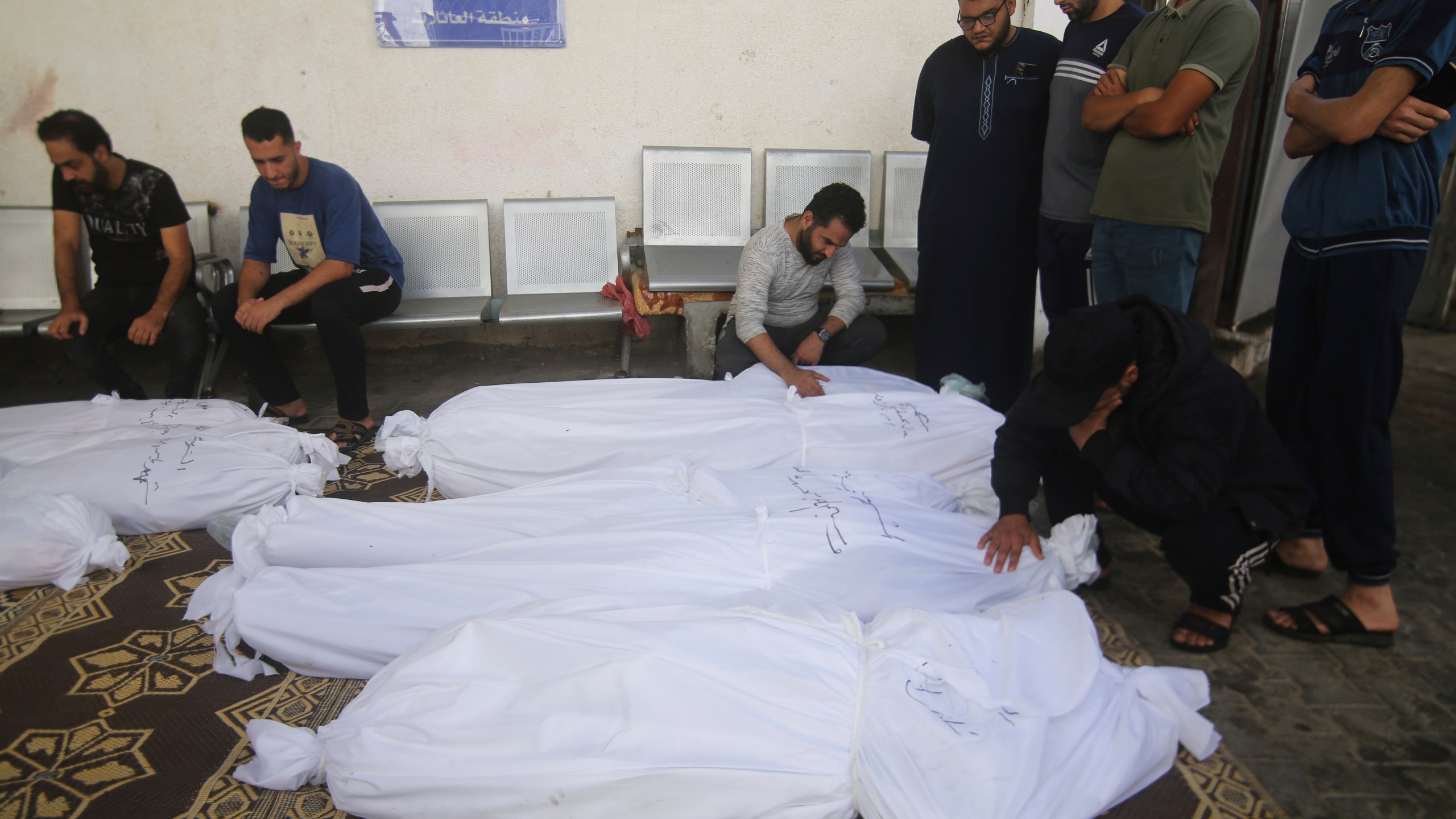 Palestinians gather around the bodies of their relatives who were killed by an Israeli airstrike, at the hospital in Rafah, Gaza Strip, Friday, Oct. 13, 2023. (AP Photo/Hatem Ali)