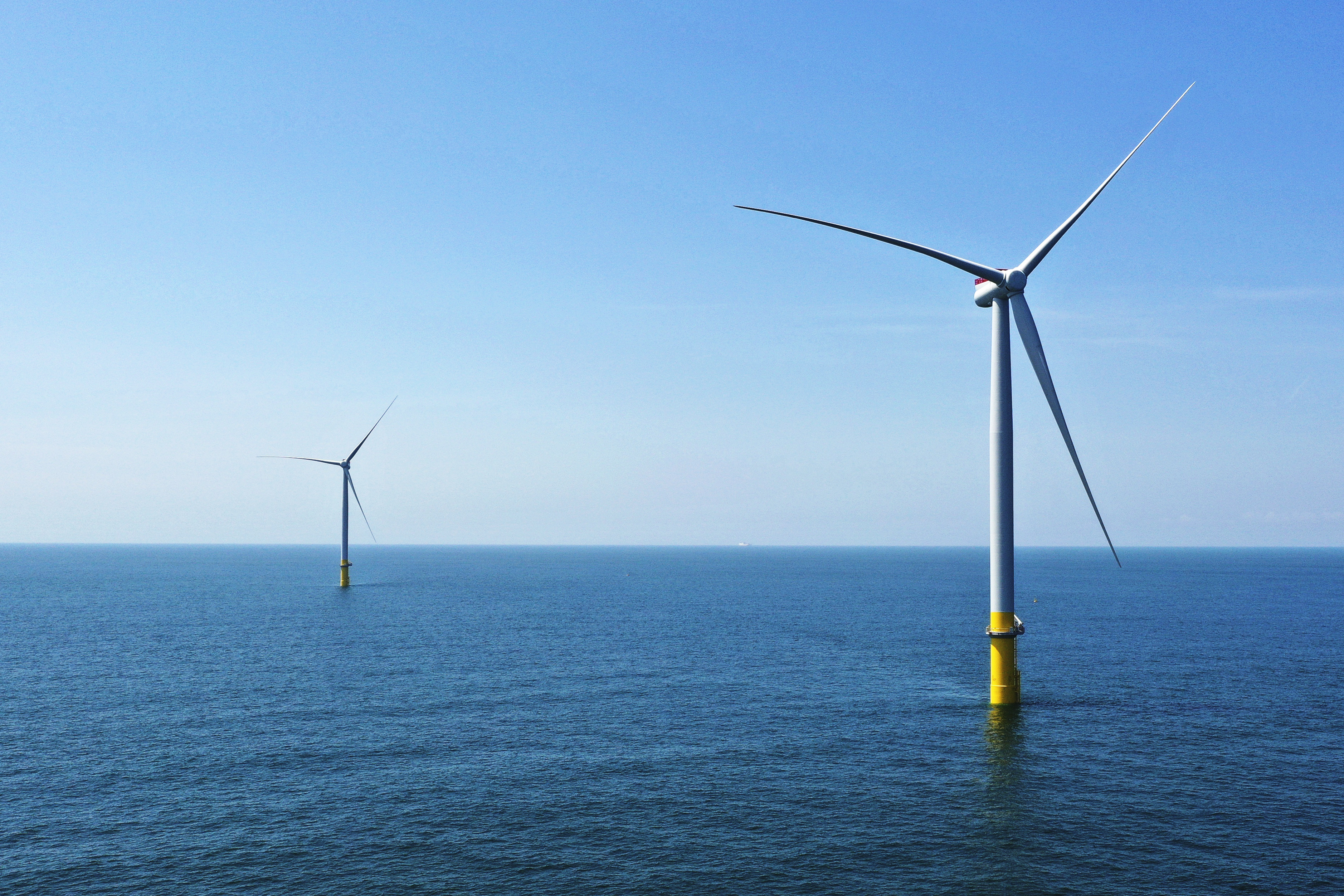 FILE - Two of the offshore wind turbines have been constructed off the coast of Virginia Beach, Va., June 29, 2020. A power company's plans for an enormous offshore wind farm off Virginia's coast achieved a major regulatory milestone Tuesday, Oct. 31, 2023, after the Biden Administration evaluated the project's potential impact on the environment. (AP Photo/Steve Helber, File)