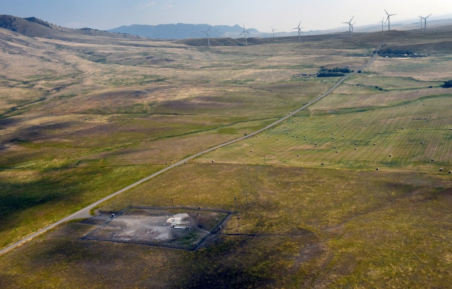 In this image provided by the U.S. Air Force, wind turbines spin near the Malmstrom Air Force Base missile launch site Alpha-03 in Geyser, Mont., in August 2023. As the nation's energy needs have increased, turbines have grown in size and number, and are being placed closer to the underground silos where Minuteman III intercontinental ballistic missiles are kept ready to fire. The Air Force is concerned that the turbines are making it dangerous for their helicopter crews to fly out to the sites, often flying low and fast, when responding to an alarm at one of the silos. The service is seeking a two nautical mile buffer zone around the sites. (John Turner/U.S. Air Force via AP)