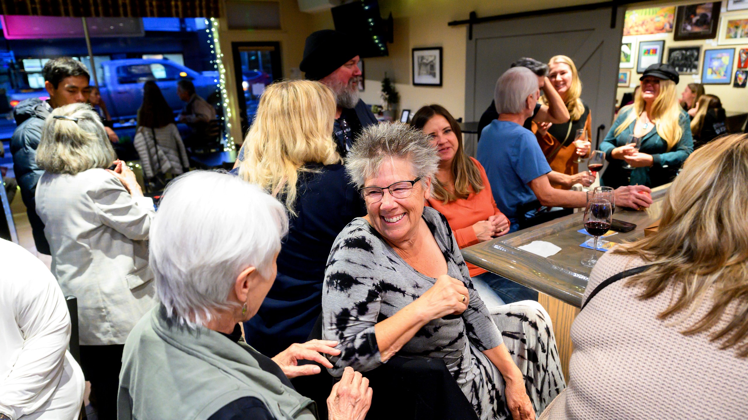 Sandy Miller speaks with Nic's Deli & Wine Bar owner Nikki Jones, left, Wednesday, Oct. 25, 2023, in Paradise, Calif. Jones lost two businesses in 2018's Camp Fire. (AP Photo/Noah Berger)