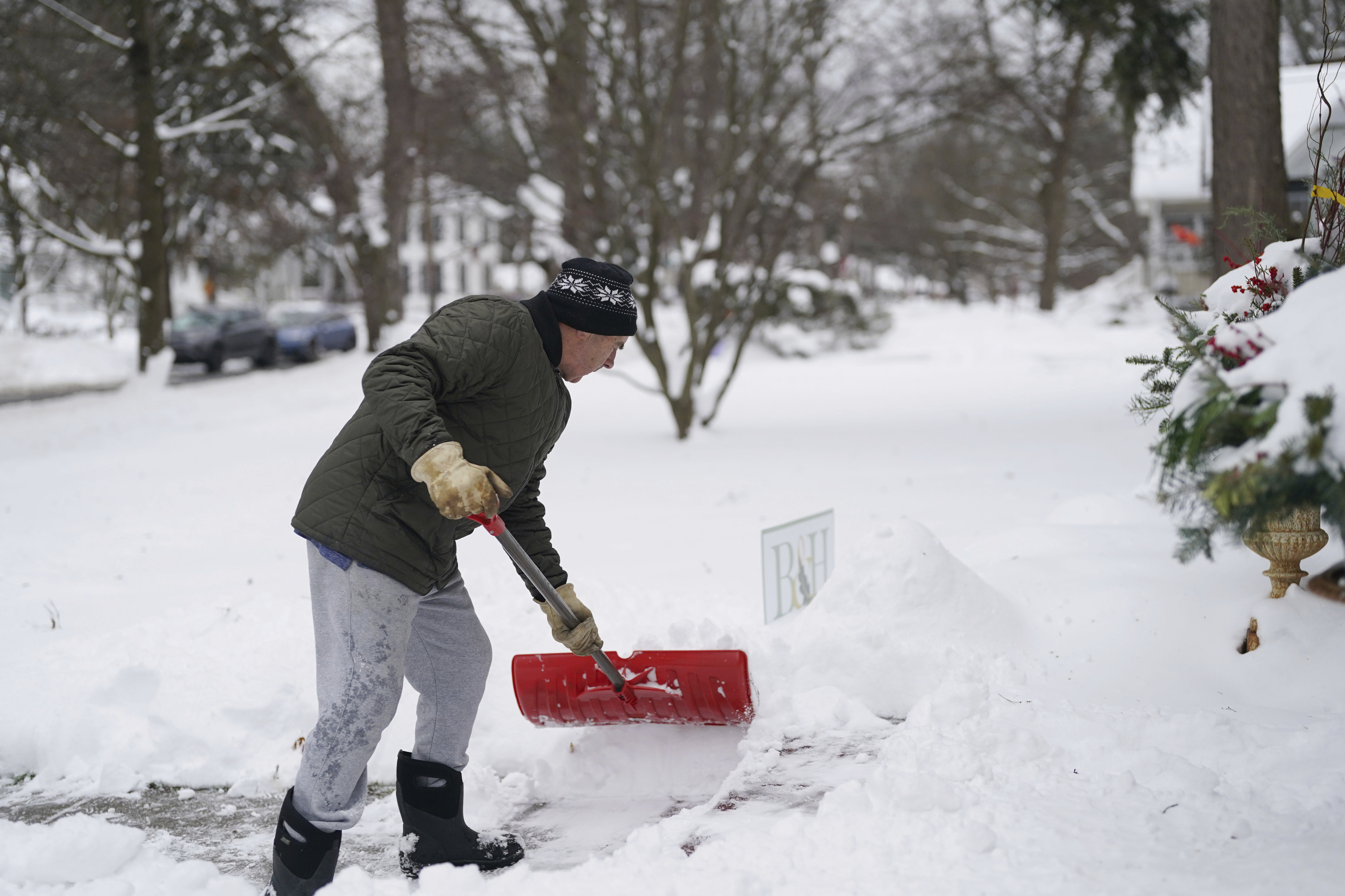 Jack Vickerd shovels his front sidewalk on Girard Avenue in East Aurora, N.Y. Tuesday, Nov. 28, 2023. (Derek Gee/The Buffalo News via AP)
