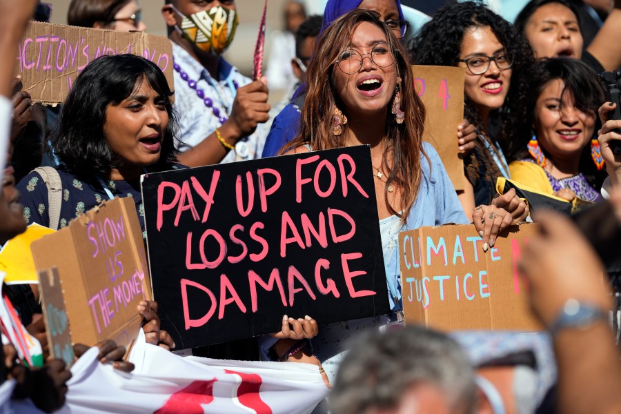 FILE - Mitzi Jonelle Tan, of the Philippines, center, participates in a Fridays for Future protest calling for money for climate action at the COP27 U.N. Climate Summit, Nov. 11, 2022, in Sharm el-Sheikh, Egypt. (AP Photo/Peter Dejong, File)