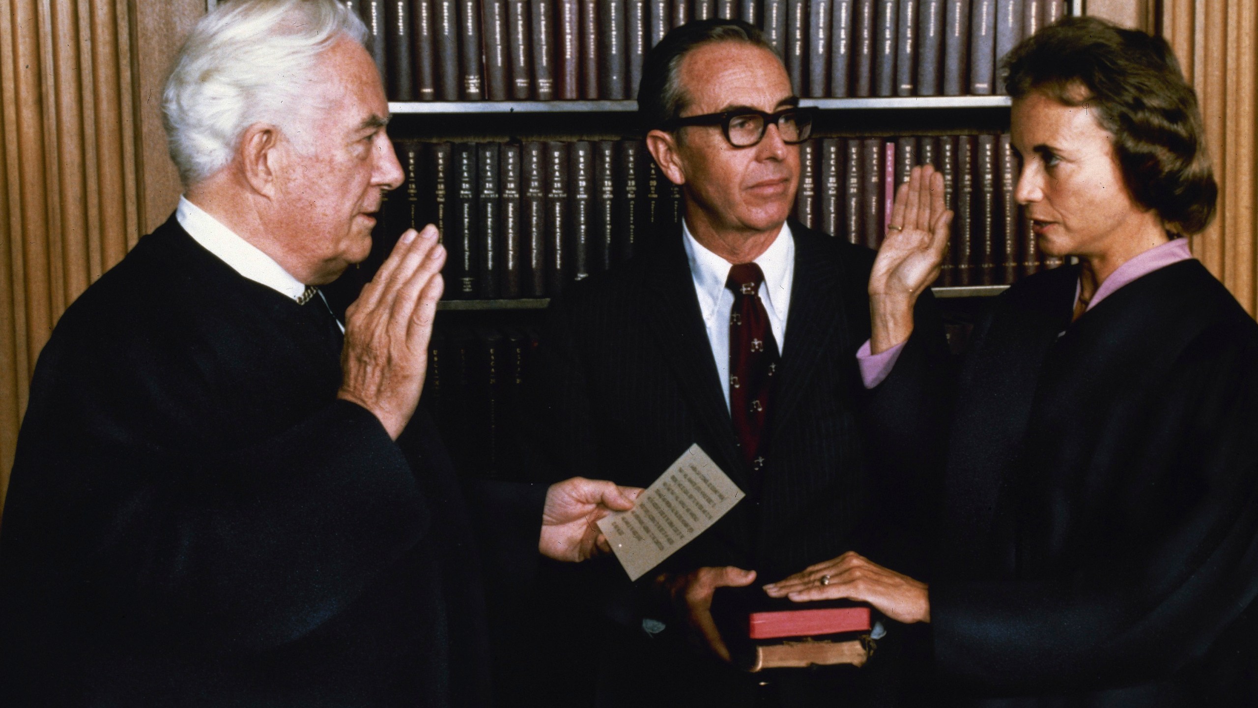 FILE - In this photo released by the White House, Justice Sandra Day O'Connor, the first female justice of the Supreme Court, is sworn in by Chief Justice Warren Burger in the court's conference room in Washington, Sept. 25, 1981. Justice O'Connor's husband John holds two family Bibles. O'Connor, who joined the Supreme Court in 1981 as the nation's first female justice, has died at age 93. (AP Photo/The White House, File)