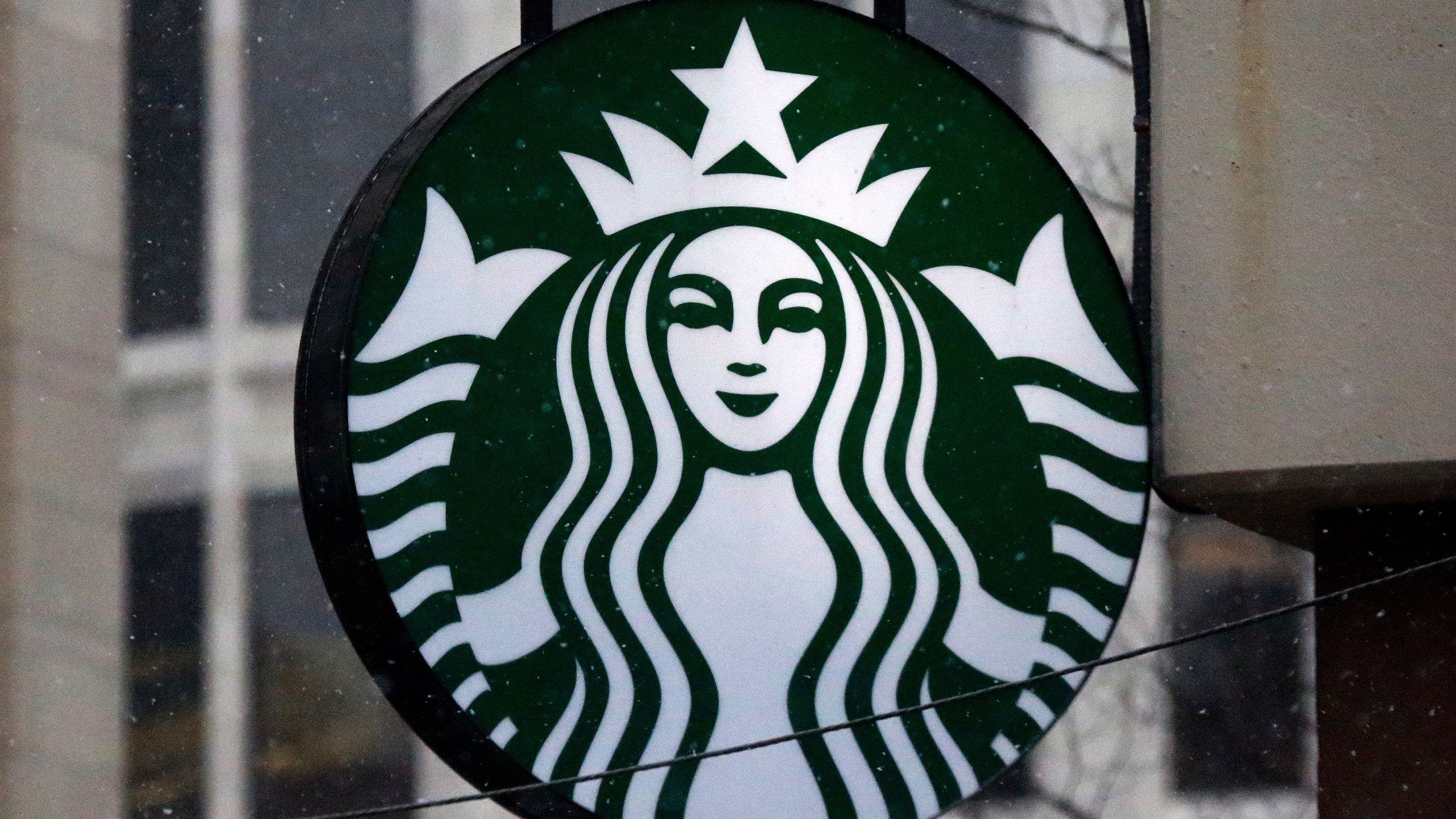 FILE - The Starbucks logo is seen, March 14, 2017, on a shop in downtown Pittsburgh. Business closings on Christmas Eve are less common than those on Christmas Day, but many large chains still cut back hours or close up shop early for the coming holiday. Many Starbucks locations will be open on Christmas Eve, Sunday, Dec. 24, 2023, but hours can vary. (AP Photo/Gene J. Puskar, File)