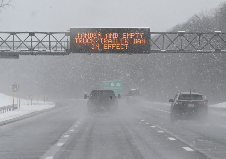 FILE - A roadway caution sign is seen on the New York Thruway as motorists commute during a winter snow storm, March 14, 2023, in Albany, N.Y. A winter weather system moving through the U.S. is expected to wallop the East Coast this weekend, Saturday, Jan. 6, 2024, into Sunday, Jan. 7, with a mix of snow and freezing rain from the southern Appalachians to the Northeast — although it's too early to say exactly which areas will get what precipitation and how much. (AP Photo/Hans Pennink, File)