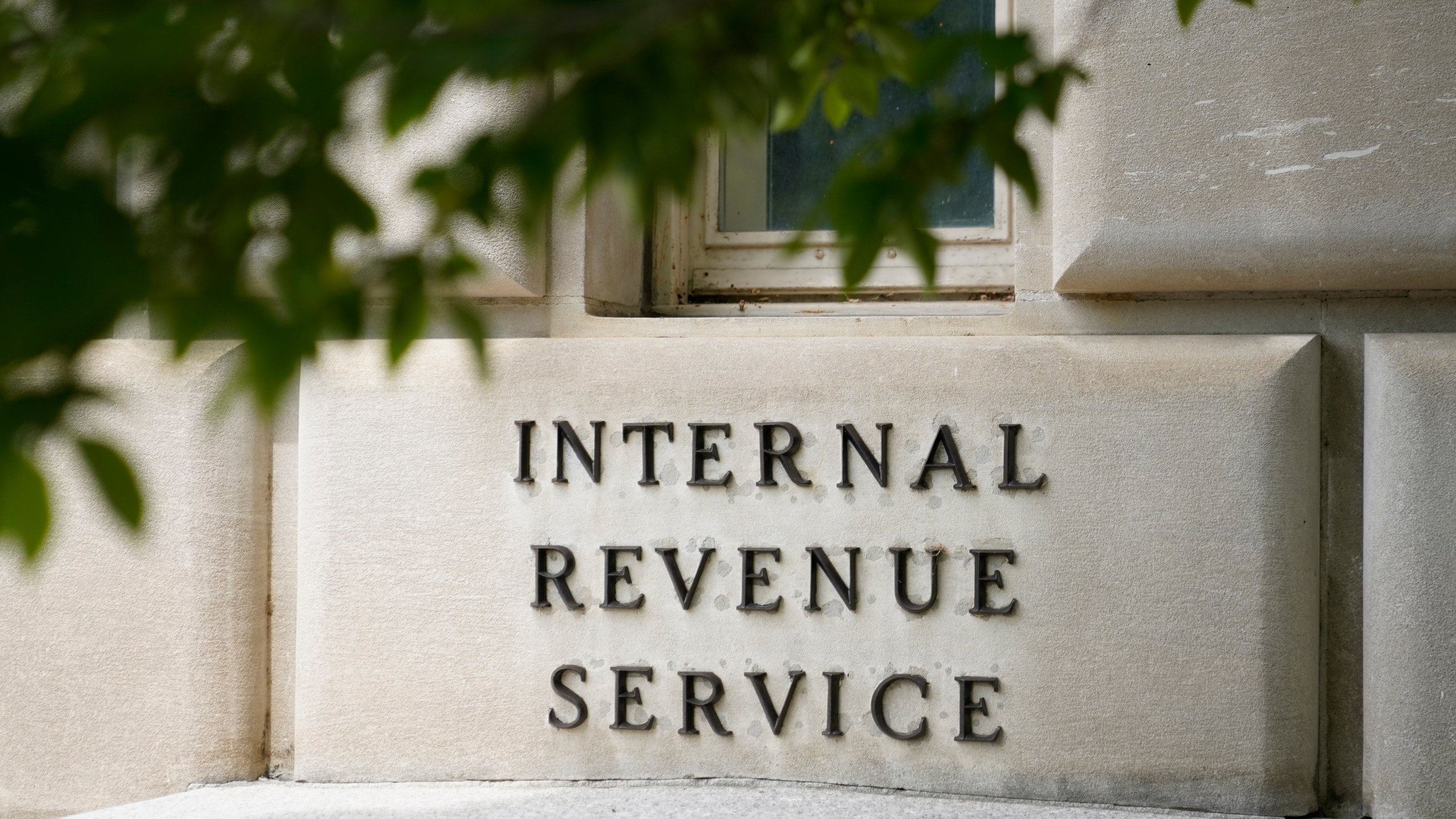 FILE - A sign outside the Internal Revenue Service building is seen, May 4, 2021, in Washington. The IRS wants to rewrite its complicated letters to taxpayers and speak to people in plain English. The IRS is rewriting and sending out commonly received notices ahead of the 2024 tax filing season as part of its new "Simple Notice Initiative." Treasury Secretary Janet Yellen said Tuesday, Jan. 23, 2024, "Redesigned notices will be shorter, clearer and easier to understand." (AP Photo/Patrick Semansky, File)