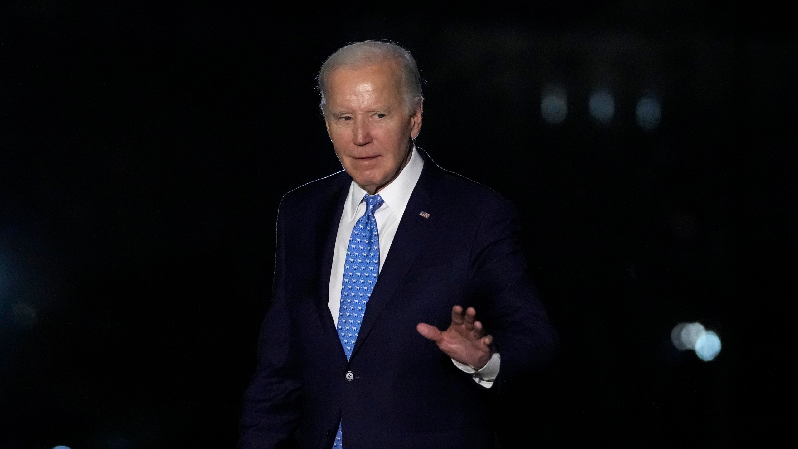 President Joe Biden waves as he walks across the South Lawn of the White House in Washington, Tuesday, Jan. 30, 2024, after returning from a trip to Florida. (AP Photo/Susan Walsh)