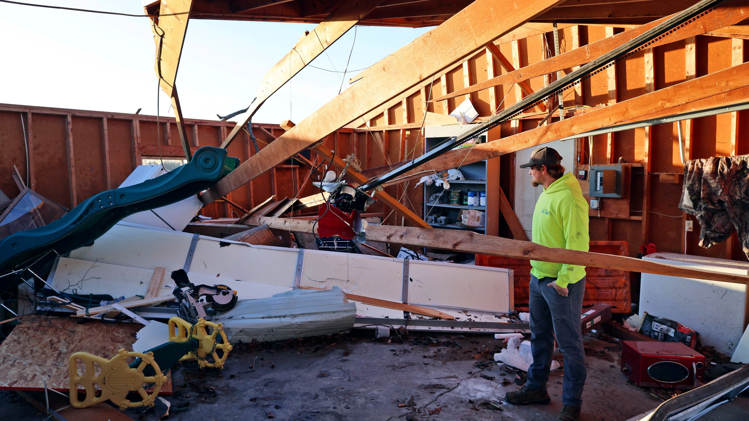 Patrick Crull tours the damage inside the detached garage next to his home Friday morning, Feb. 9, 2024, after a confirmed tornado went through the area just northwest of Evansville,Wis., the prior evening. The tornado was the first-ever reported in February in the state of Wisconsin, according to the National Weather Service. (Anthony Wahl//The Janesville Gazette via AP)