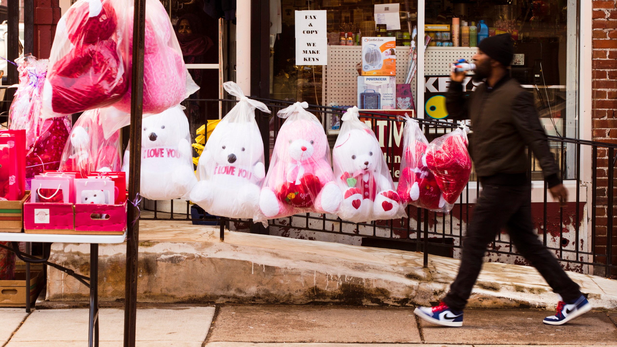 FILE - A pedestrian passes Valentine's day stuffed animals for sale ahead of the holiday in Philadelphia, Feb. 13, 2019. This is the first Valentine's Day since the U.S. surgeon general issued a public health advisory declaring loneliness and isolation an epidemic with dire consequences. (AP Photo/Matt Rourke, file)