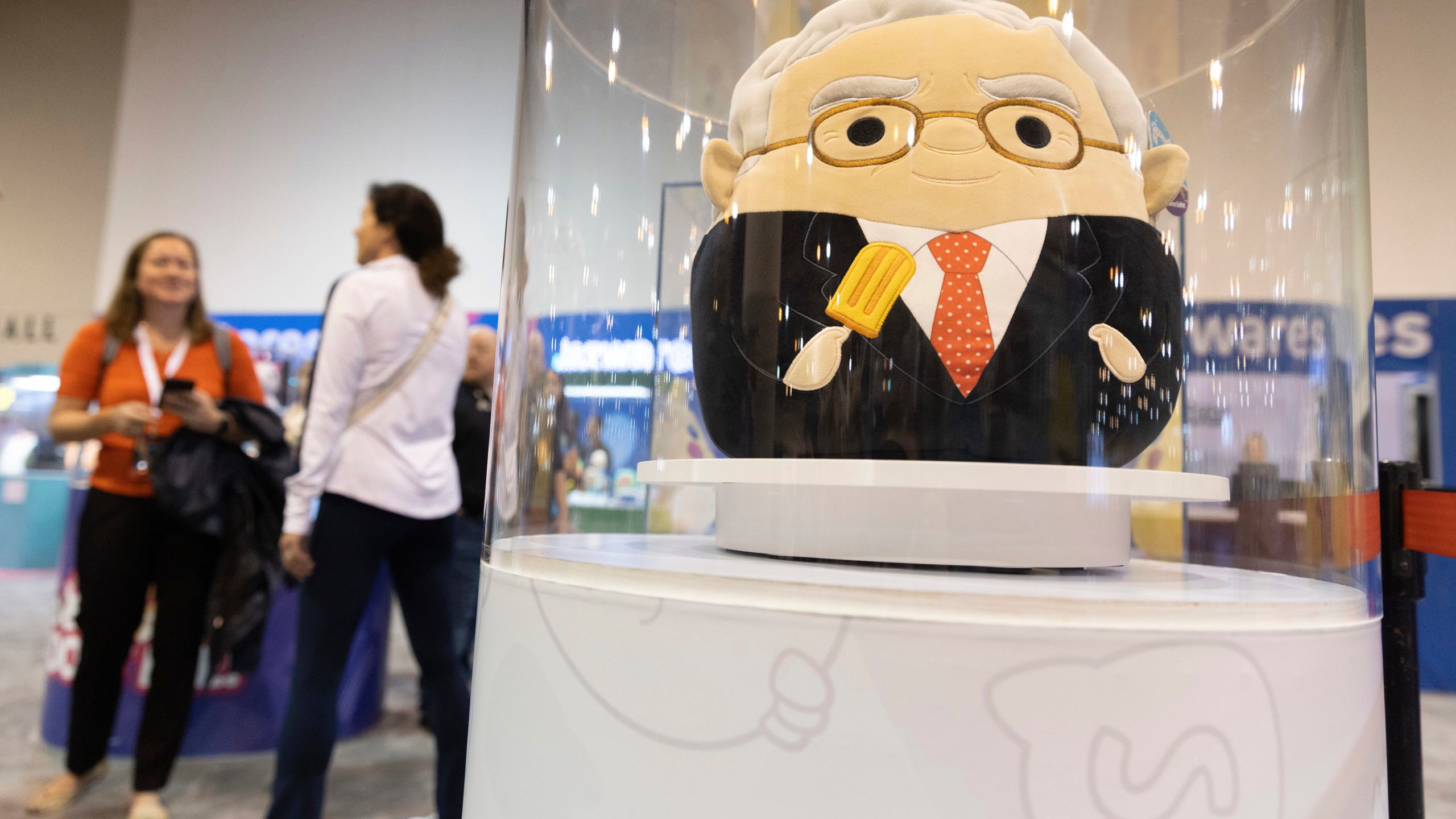 FILE - The Squishmallows booth sells toys modeled after Warren Buffett, pictured, and Charlie Munger in the exhibit hall for the Berkshire Hathaway annual meeting, Saturday, May 6, 2023, in Omaha, Neb. In a lawsuit filed Monday, Feb. 12, 2024, Kelly Toys and parent company Jazwares accused Build-A-Bear's new “Skoosherz” line of copying Squishmallows' look and feel. Skoosherz toys have the “same distinctive trade dress” of Squishmallows, the complaint said — pointing to shape, face style, coloring and fabric similarities. (AP Photo/Rebecca S. Gratz, File)