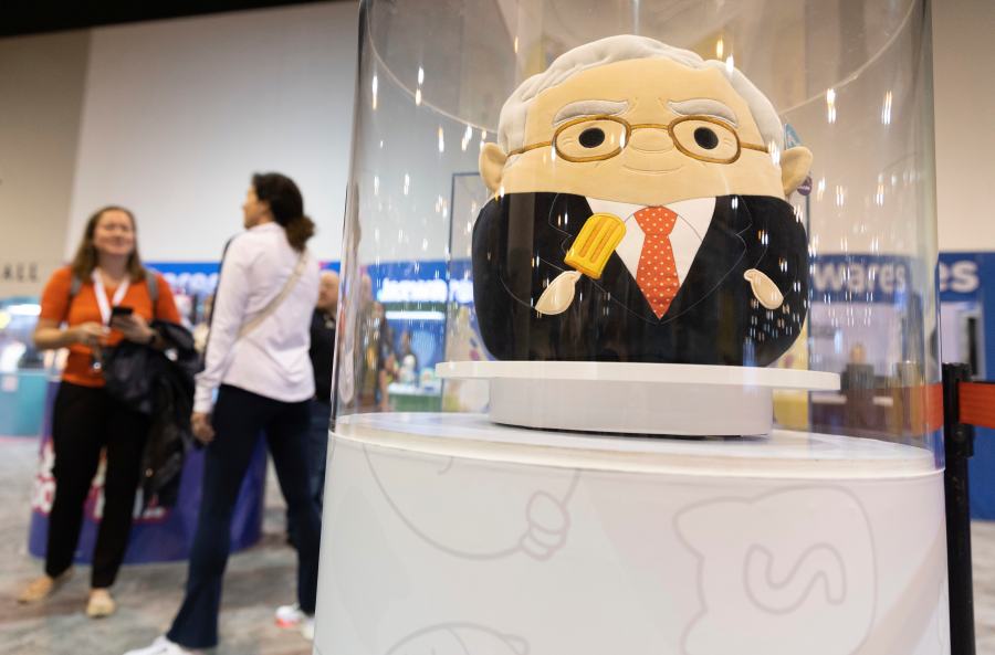 FILE - The Squishmallows booth sells toys modeled after Warren Buffett, pictured, and Charlie Munger in the exhibit hall for the Berkshire Hathaway annual meeting, Saturday, May 6, 2023, in Omaha, Neb. In a lawsuit filed Monday, Feb. 12, 2024, Kelly Toys and parent company Jazwares accused Build-A-Bear's new “Skoosherz” line of copying Squishmallows' look and feel. Skoosherz toys have the “same distinctive trade dress” of Squishmallows, the complaint said — pointing to shape, face style, coloring and fabric similarities. (AP Photo/Rebecca S. Gratz, File)