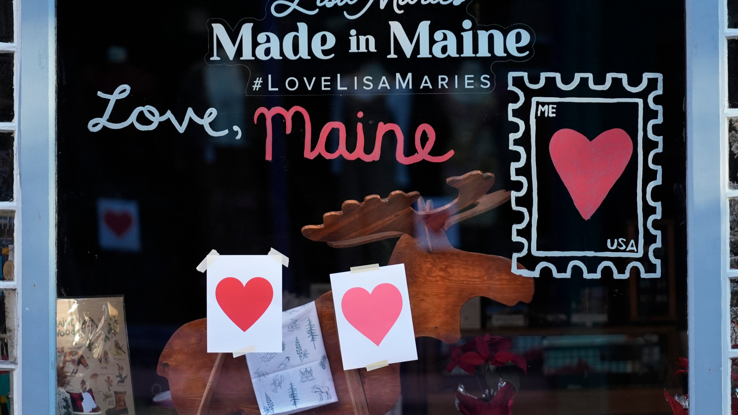 Valentine's Day hearts decorate a shop, Wednesday, Feb. 14, 2024, in Portland, Maine. The public has helped honor the memory of Kevin Fahrman, the Valentine's Day Bandit who secretly hung hundreds of red paper hearts throughout the city every February 14th. Farman died last year. (AP Photo/Robert F. Bukaty)