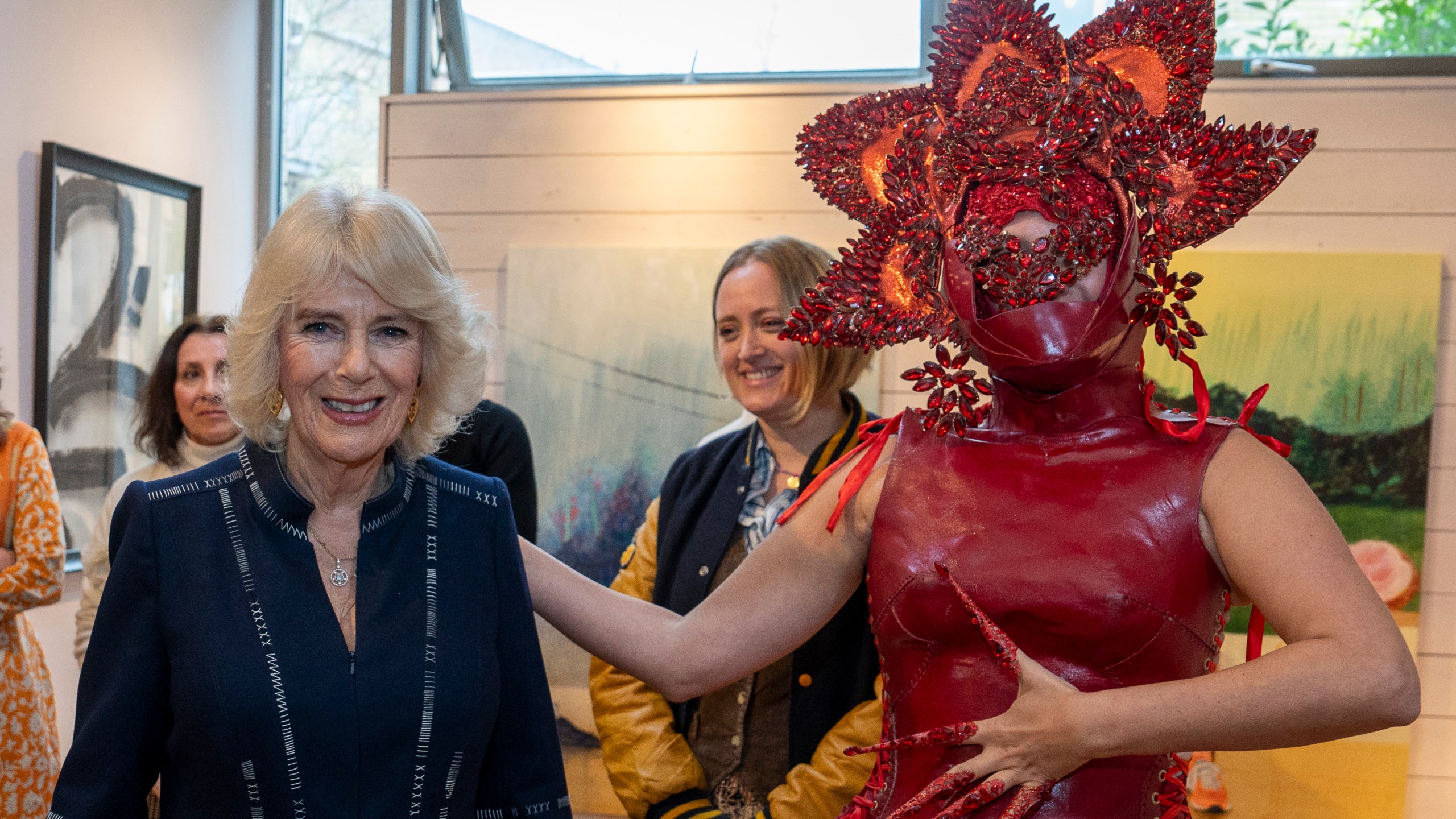 FILE - Britain's Queen Camilla, left, meets costume designer Syban Velardi-Laufer during her visit to Kindred Studios' Shepherds Bush pop-up hub, an art studios and creative space encouraging arts, crafts and community cohesion, in London, Wednesday, Feb. 14, 2024. Queen Camilla, once seen as the scourge of the House of Windsor, the woman at the heart of King Charles III’s doomed marriage to the late Princess Diana, has emerged as one of the monarchy’s most prominent emissaries. (Arthur Edwards/Pool Photo via AP, File)