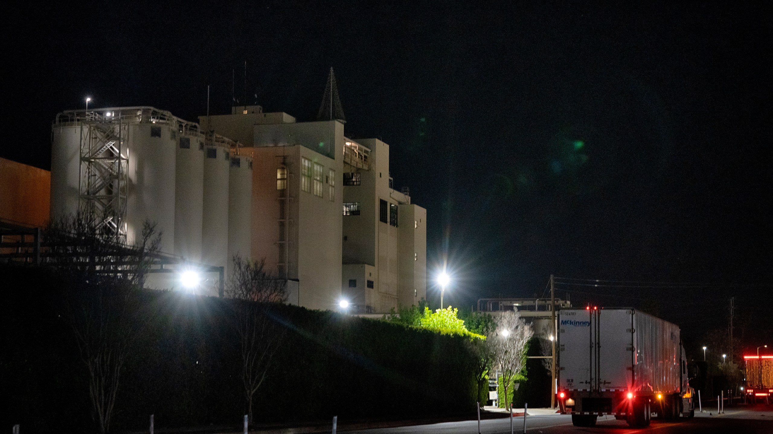 A transport truck waits outside of the Anheuser Busch factory in the Van Nuys section of Los Angeles on Wednesday, Feb. 28, 2024. A standoff between brewery workers and Anheuser-Busch might lead to the first strike by the company's unionized employees in the U.S. since 1976. But fans of Budweiser, Bud Light, Michelob and other beers don't need to worry about going dry. (AP Photo/Richard Vogel)