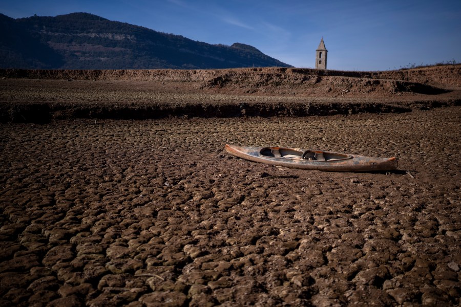 FILE - An abandoned canoe sits on the cracked ground amid a drought at the Sau reservoir, north of Barcelona, Spain, Monday, Jan. 22, 2024. Europe is facing growing climate risks and is unprepared for them, the European Environment Agency said in its first-ever risk assessment for the bloc Monday, March 11, 2024. (AP Photo/Emilio Morenatti, File)