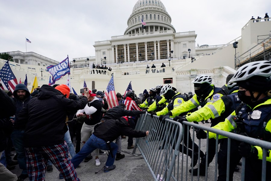 FILE - Rioters loyal to President Donald Trump push against a line of police at the U.S. Capitol in Washington on Jan. 6, 2021. House Republicans are aiming to undercut the Jan. 6 Committee's investigation with a new report that they say contradicts some of key testimony given to the panel. (AP Photo/Julio Cortez, File)