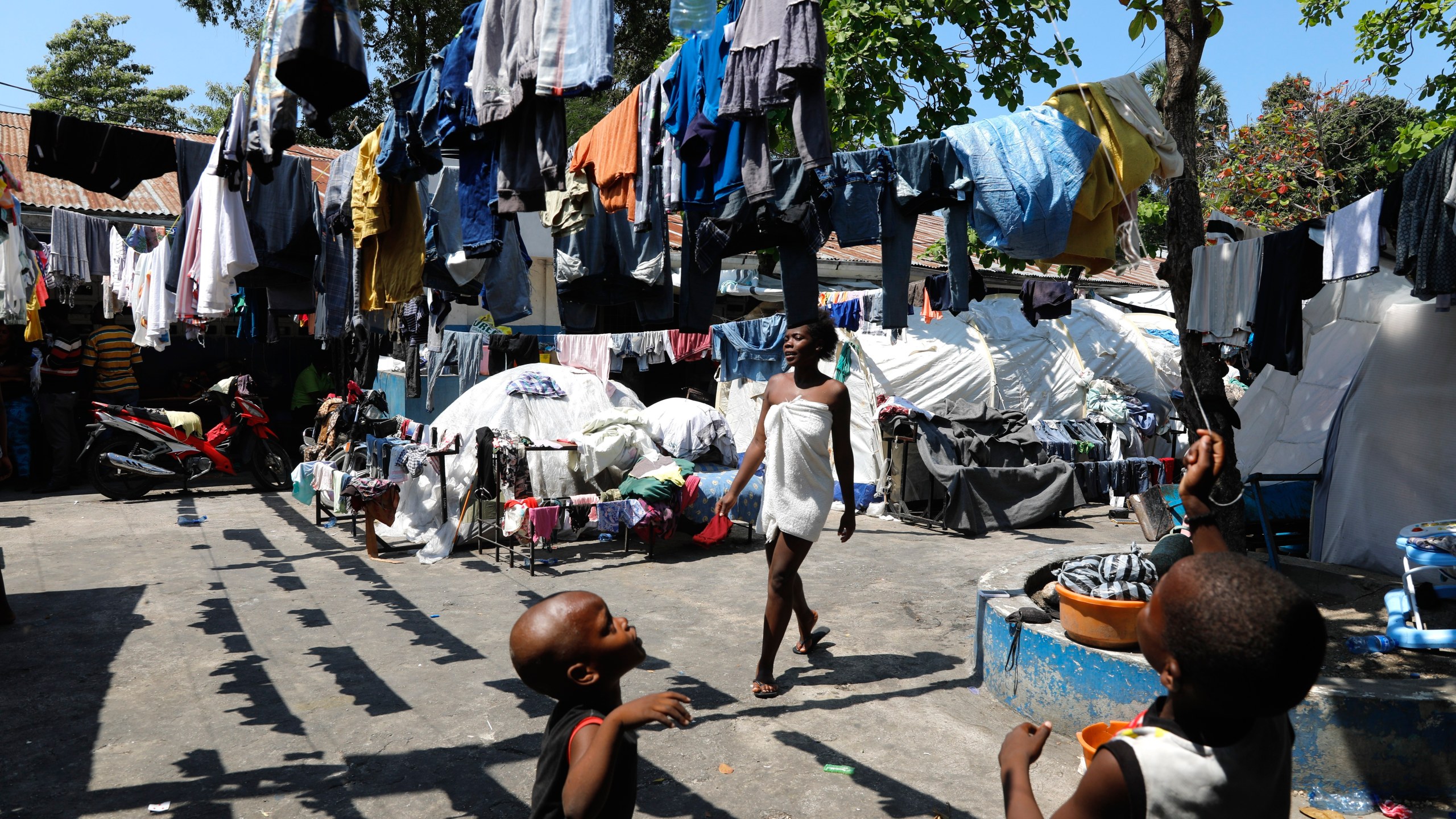 Children play in the courtyard of a shelter for families displaced by gang violence, in Port-au-Prince, Haiti, Thursday, March 14, 2024. (AP Photo/Odelyn Joseph)