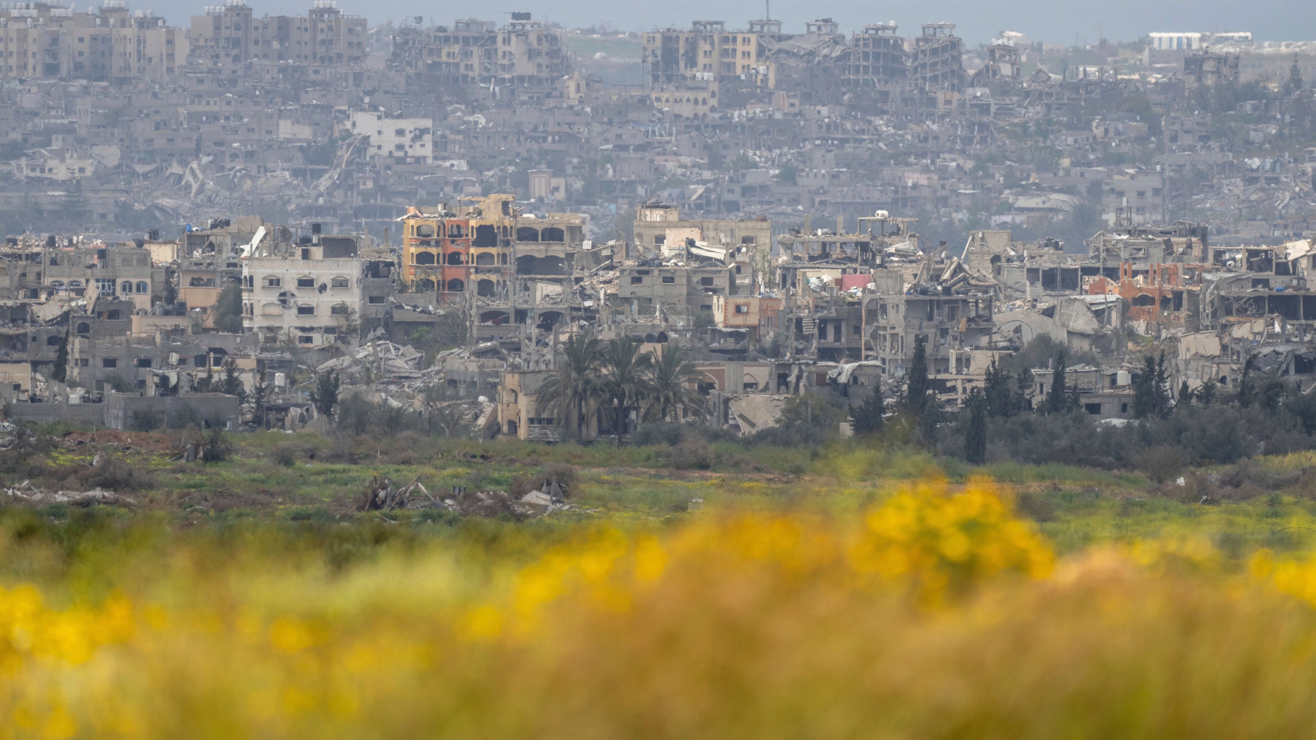 Destroyed buildings stand in the Gaza Strip as seen from southern Israel, Monday, March 18, 2024. (AP Photo/Ohad Zwigenberg)