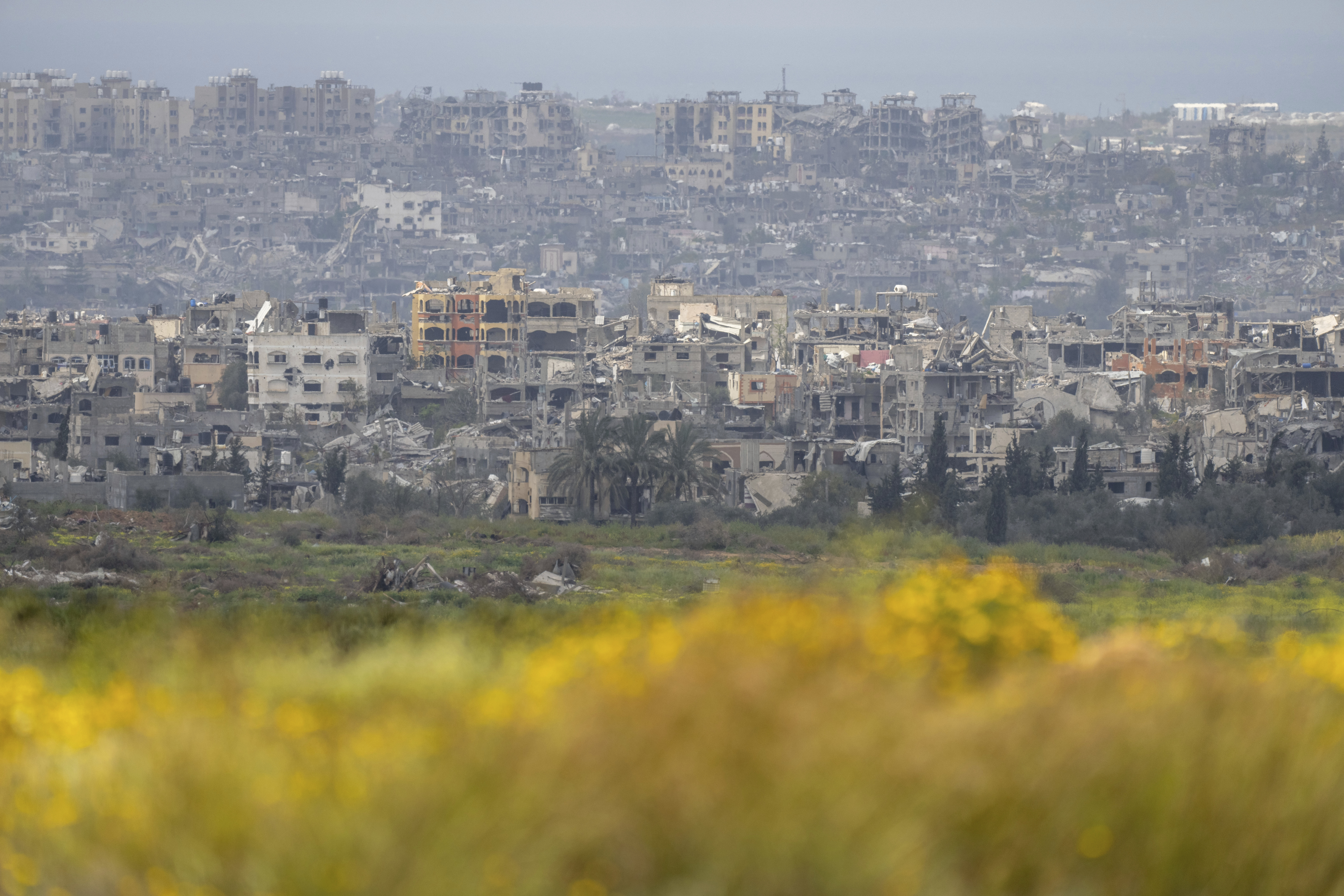 Destroyed buildings stand in the Gaza Strip as seen from southern Israel, Monday, March 18, 2024. (AP Photo/Ohad Zwigenberg)