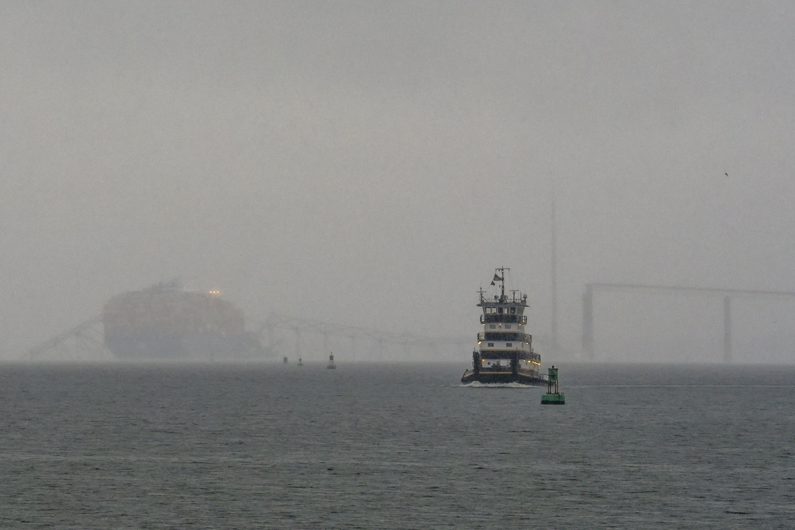 FILE - A tugboat travels along the Patapsco River as the container ship Dali rests on the wreckage of the Francis Scott Key Bridge on Wednesday, March 27, 2024, in Baltimore. (AP Photo/Matt Rourke, File)