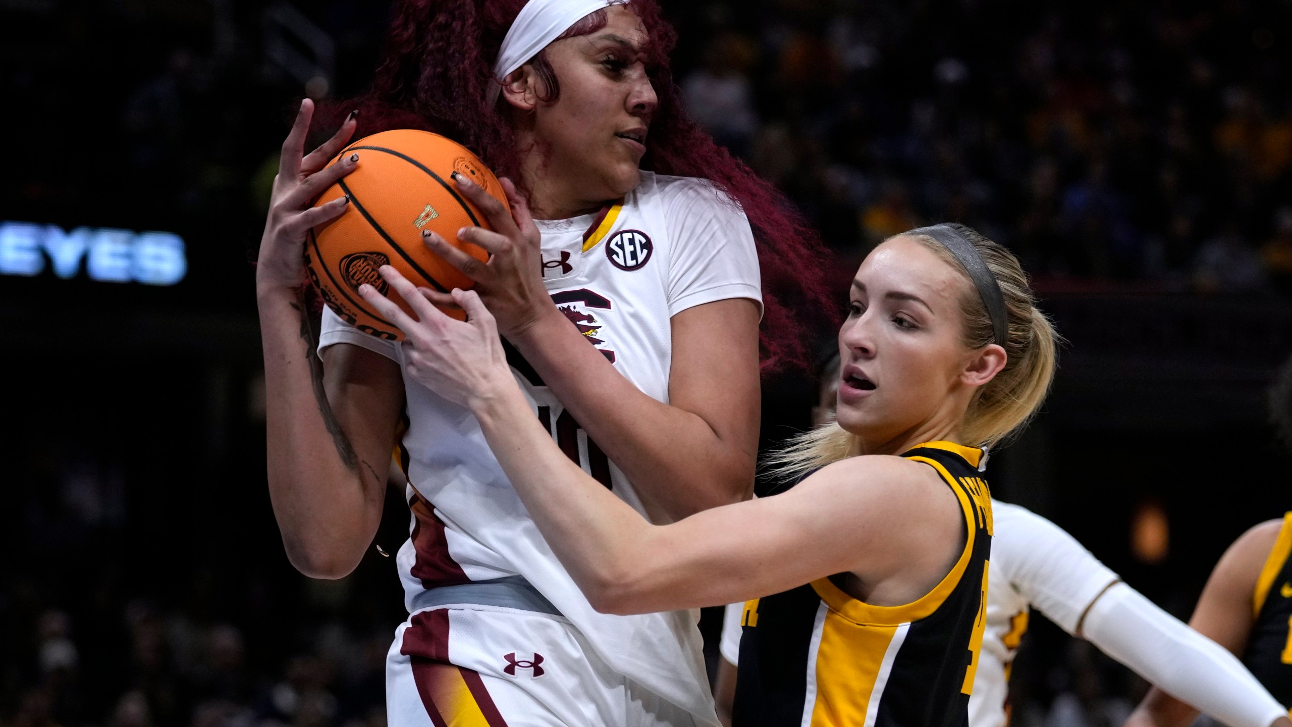 South Carolina center Kamilla Cardoso grabs a rebound over Iowa guard Kylie Feuerbach, right, during the first half of the Final Four college basketball championship game in the women's NCAA Tournament, Sunday, April 7, 2024, in Cleveland. (AP Photo/Carolyn Kaster)