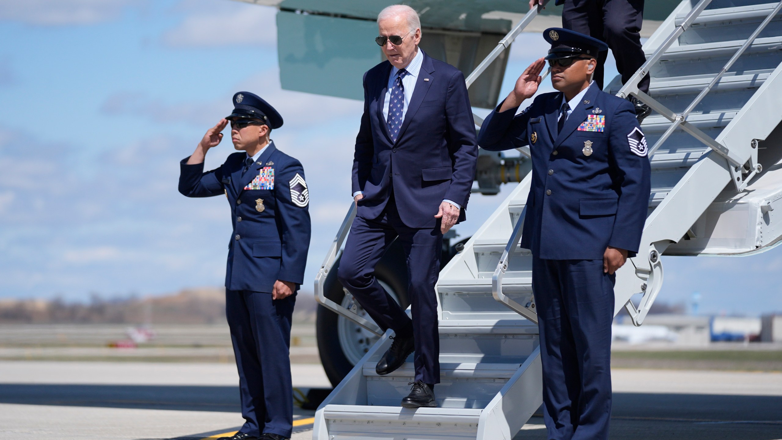 President Joe Biden, center, arrives on Air Force One at Dane County Regional Airport for an event on student loan debt at Madison College, Monday, April 8, 2024, in Madison, Wis. (AP Photo/Evan Vucci)